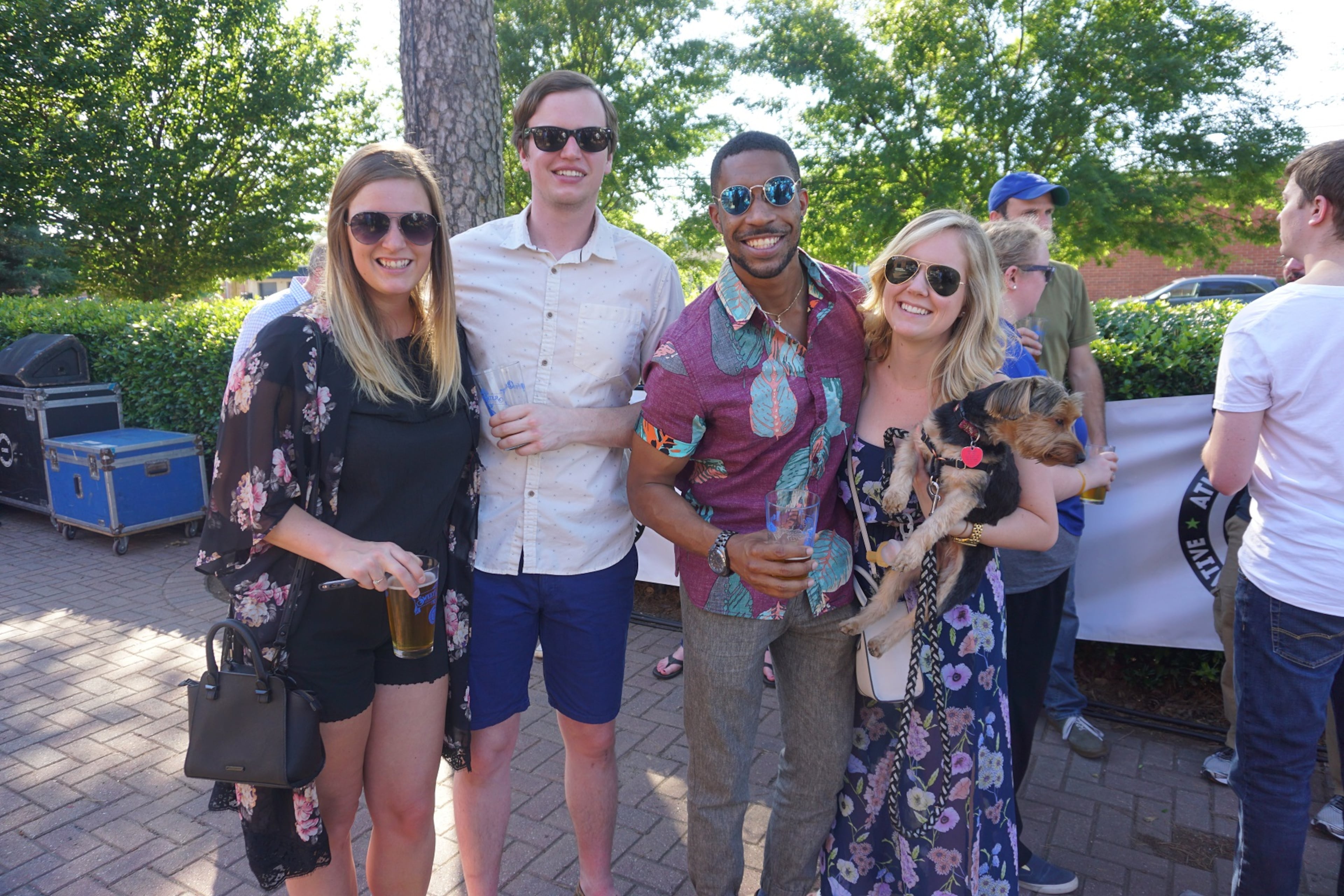 Katie Cornwell (left), Matthew Peterson, Pierre Singleton and Rachael Deja all beam with joy during SweetWater's commemorative salute to the surviving the I-85 collapse saga.