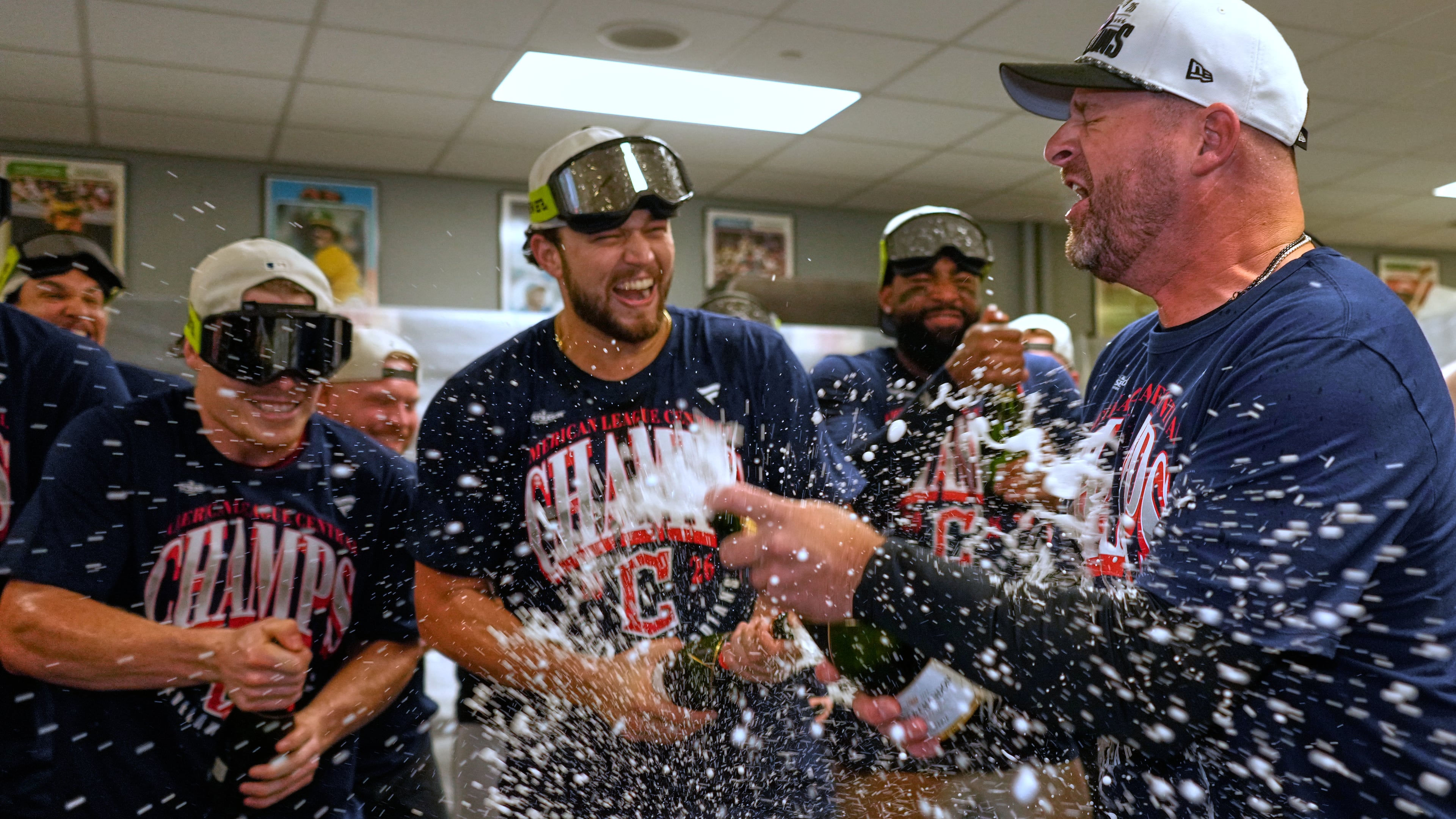 Cleveland Guardians players celebrate with manager Stephen Vogt, rigtht, after clinching the American League Central division title by defeating the Kansas City Royals in a baseball game Saturday, Sept. 26, 2026, in Kansas City, Mo. (AP Photo/Charlie Riedel)