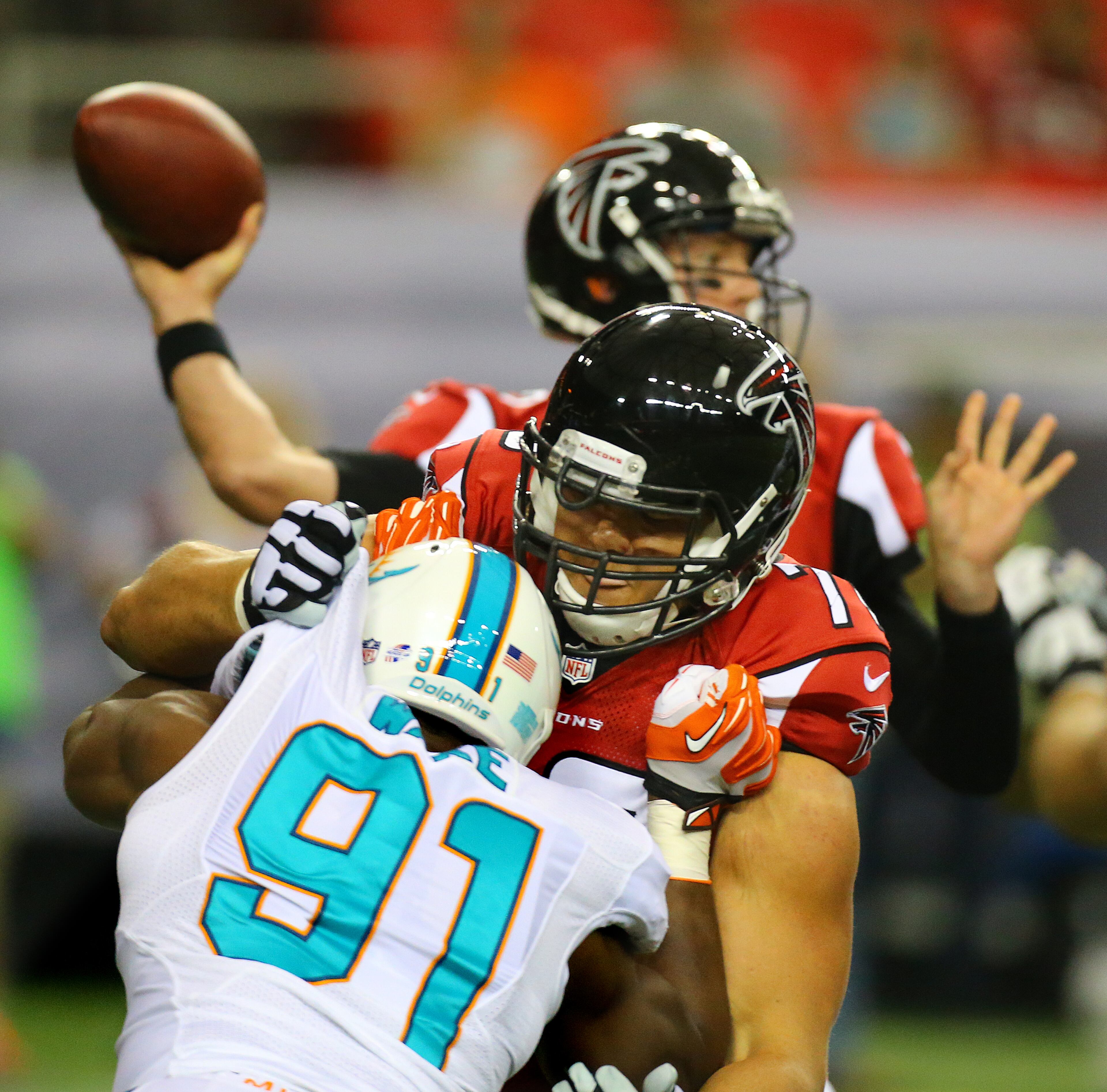 Falcons rookie offensive lineman Jake Matthews blocks Miami Dolphins defensive end Cameron Wake, giving quarterback Matt Ryan time to pass during the first quarter of their NFL exhibition game on Friday, August 8, 2014, in Atlanta.