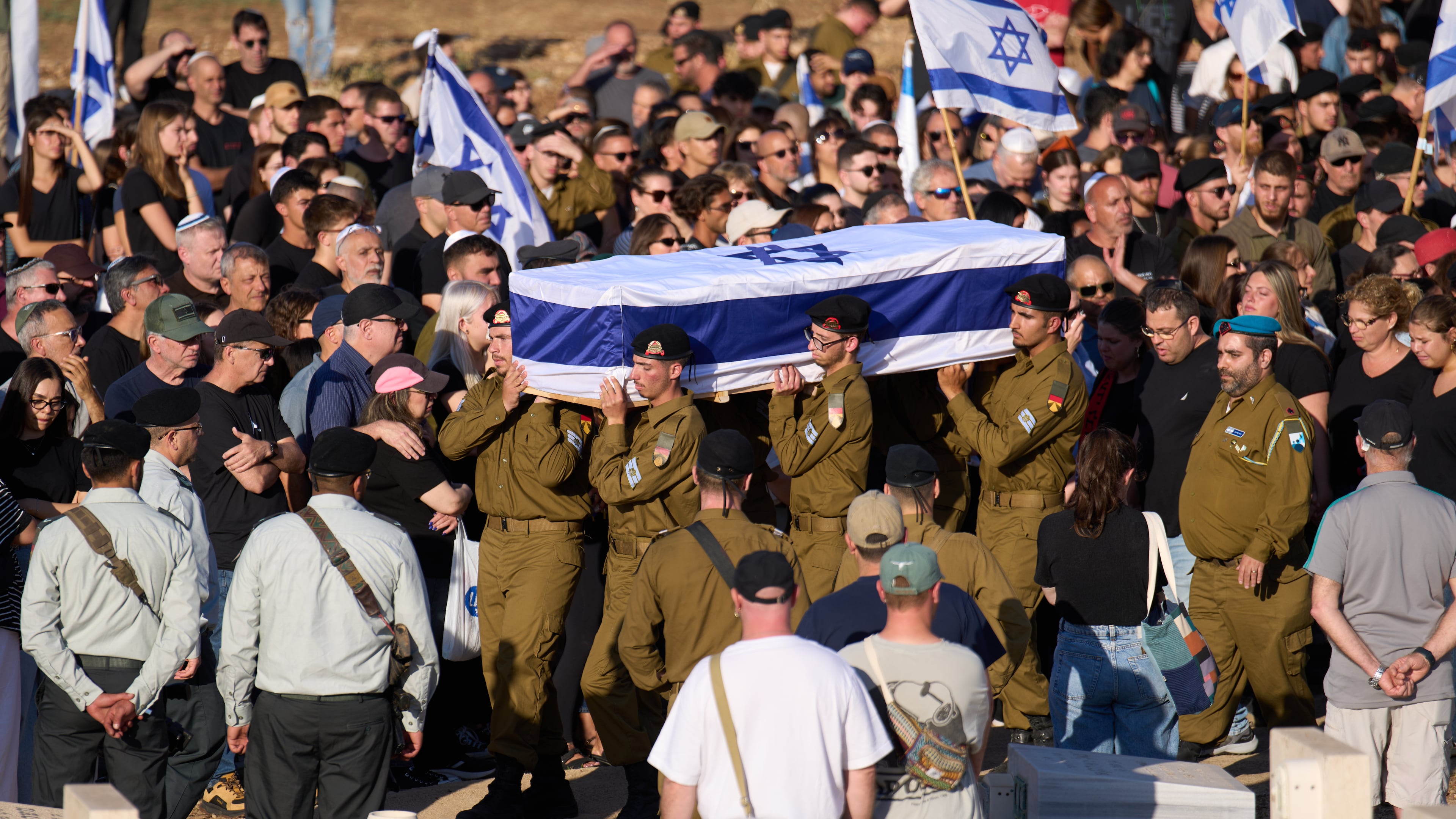 Israeli soldiers carry the casket of Staff sergeant Noam Hamburger, who was killed in a Lebanese drone attack on northern Israel, during his funeral in Atlit, Israel, Sunday, May 24, 2026. (AP Photo/Ariel Schalit)