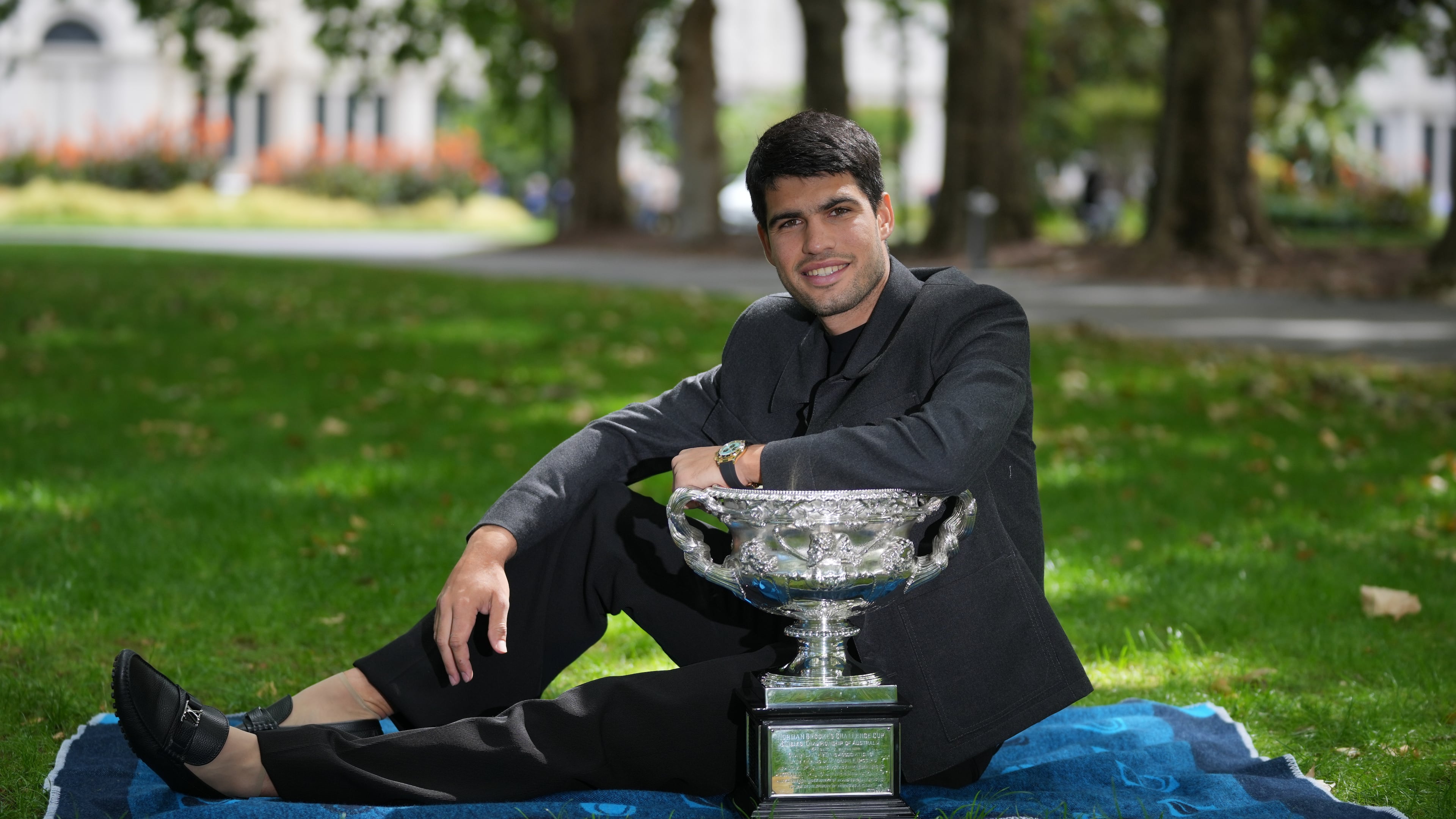 Carlos Alcaraz of Spain poses with the Norman Brookes Challenge Cup the morning after defeating Novak Djokovic of Serbia in the men's singles final at the Australian Open tennis championship, in Melbourne, Australia, Monday, Feb. 2, 2026. (AP Photo/Dita Alangkara)