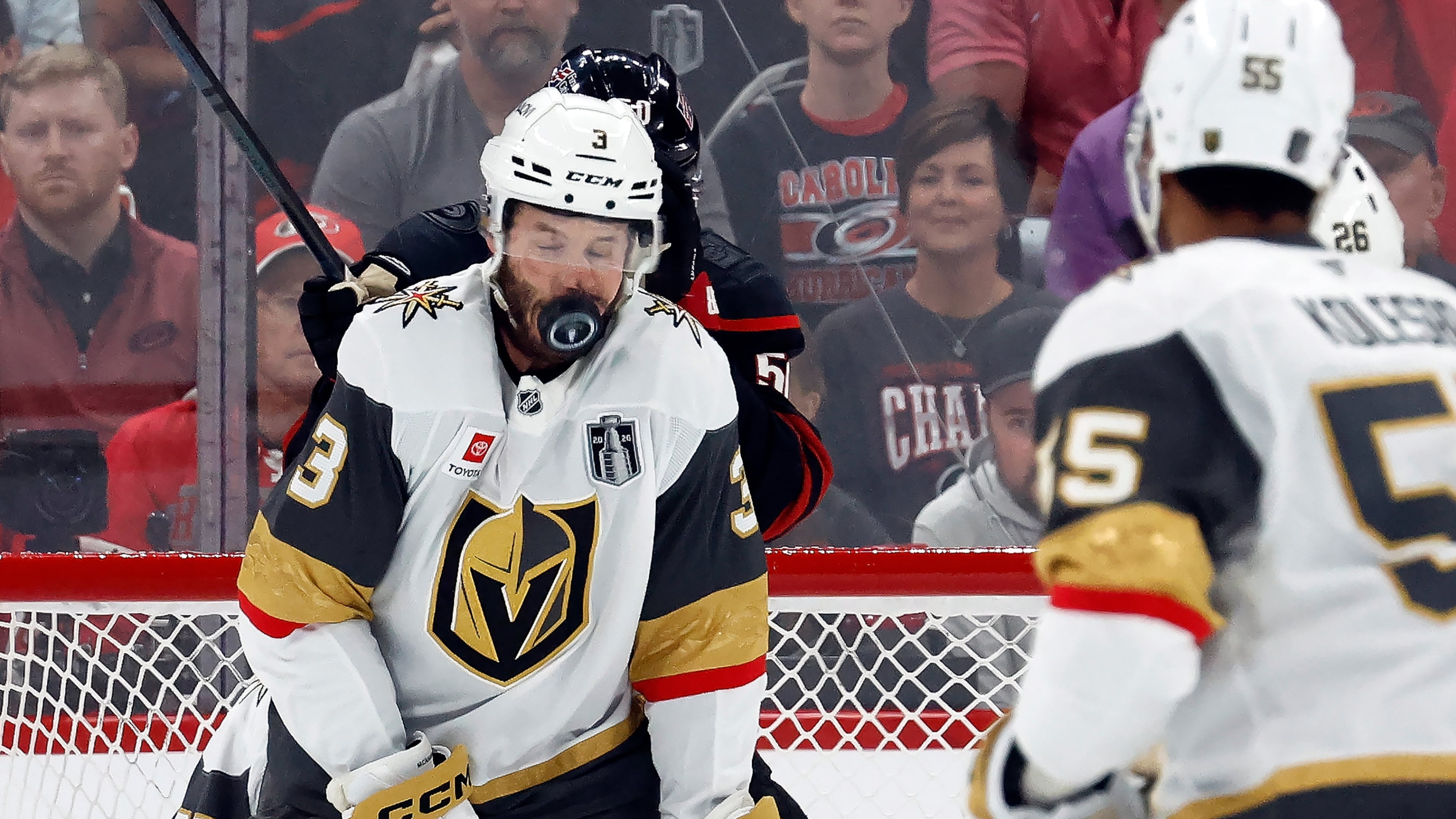 Vegas Golden Knights' Brayden McNabb takes a puck to the face during the first period in Game 2 of the NHL hockey Stanley Cup Final series against the Carolina Hurricanes in Raleigh, N.C., Thursday, June 4, 2026. (AP Photo/Karl DeBlaker)