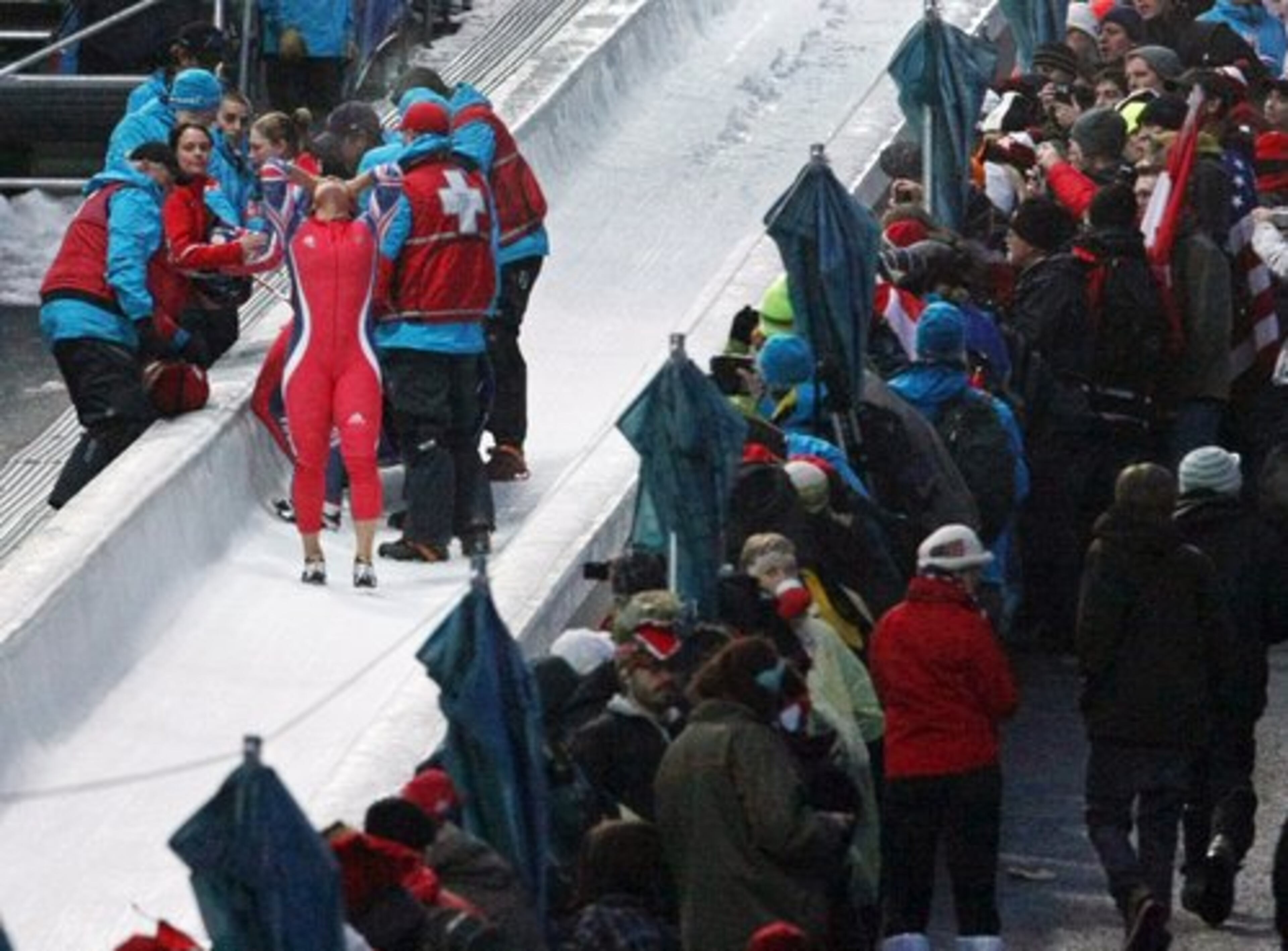 Britain's GBR-1, pilot Nicola Minichiello, front left, and brakeman Gillian Cooke, (behind her) react after crashing during the women's two-man bobsled competition final.