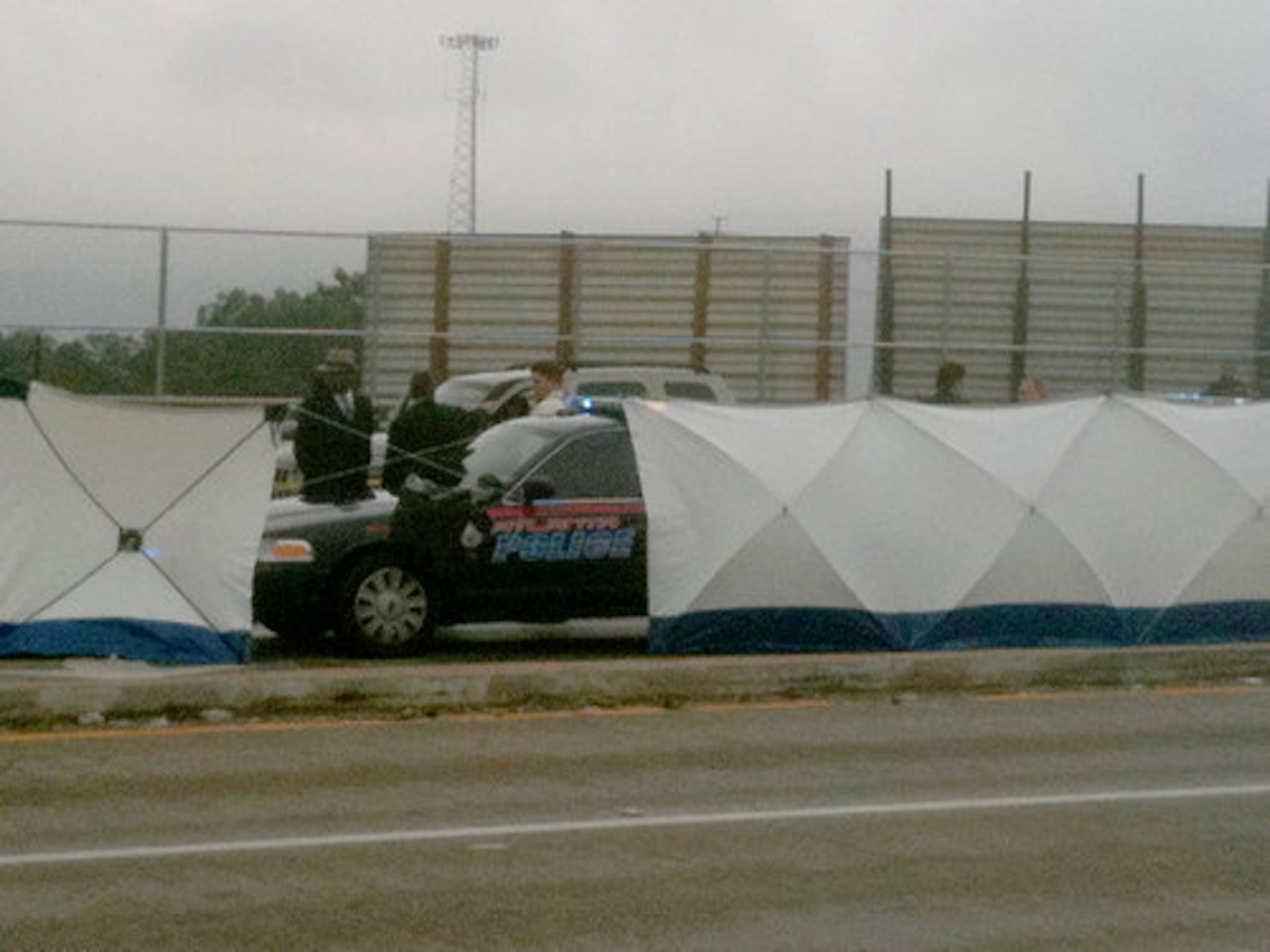 Police closed lanes and shielded the scene from motorists.