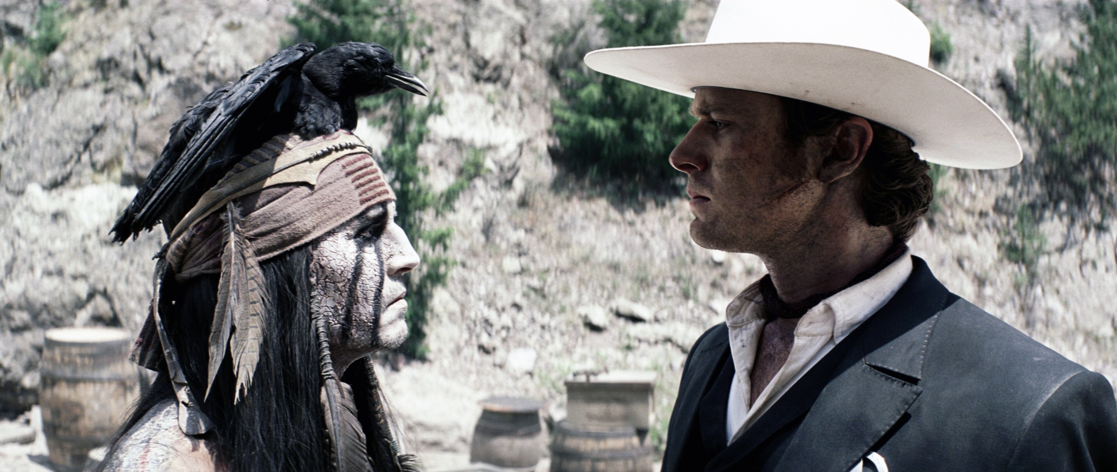 This film publicity image released by Disney shows Johnny Depp as Tonto, left, and Armie Hammer as The Lone Ranger, in a scene from "The Lone Ranger."