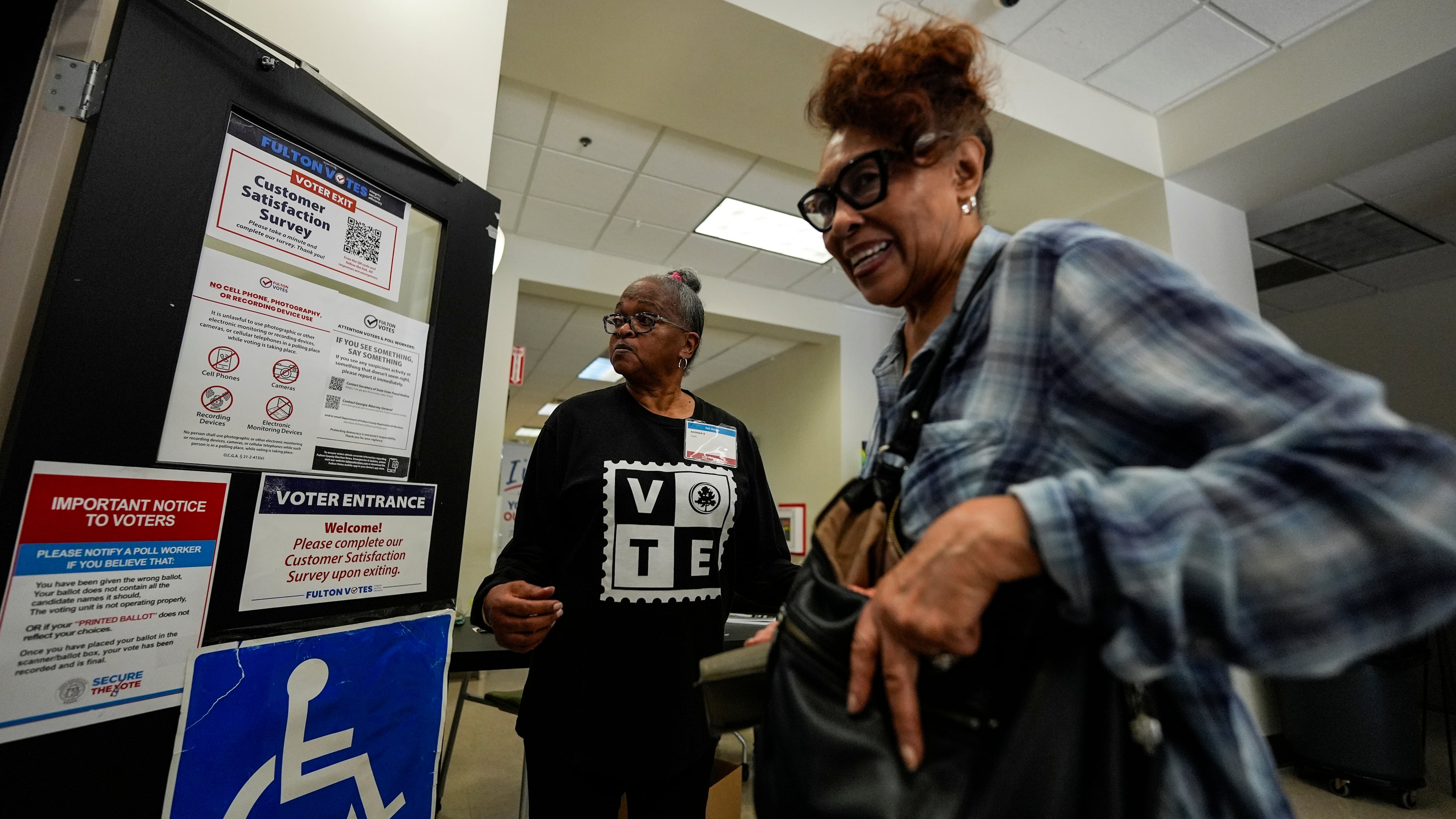 A voter enters the Southwest Arts Center voting site on the first day for early voting in Georgia, Tuesday in Atlanta. (Mike Stewart/AP)