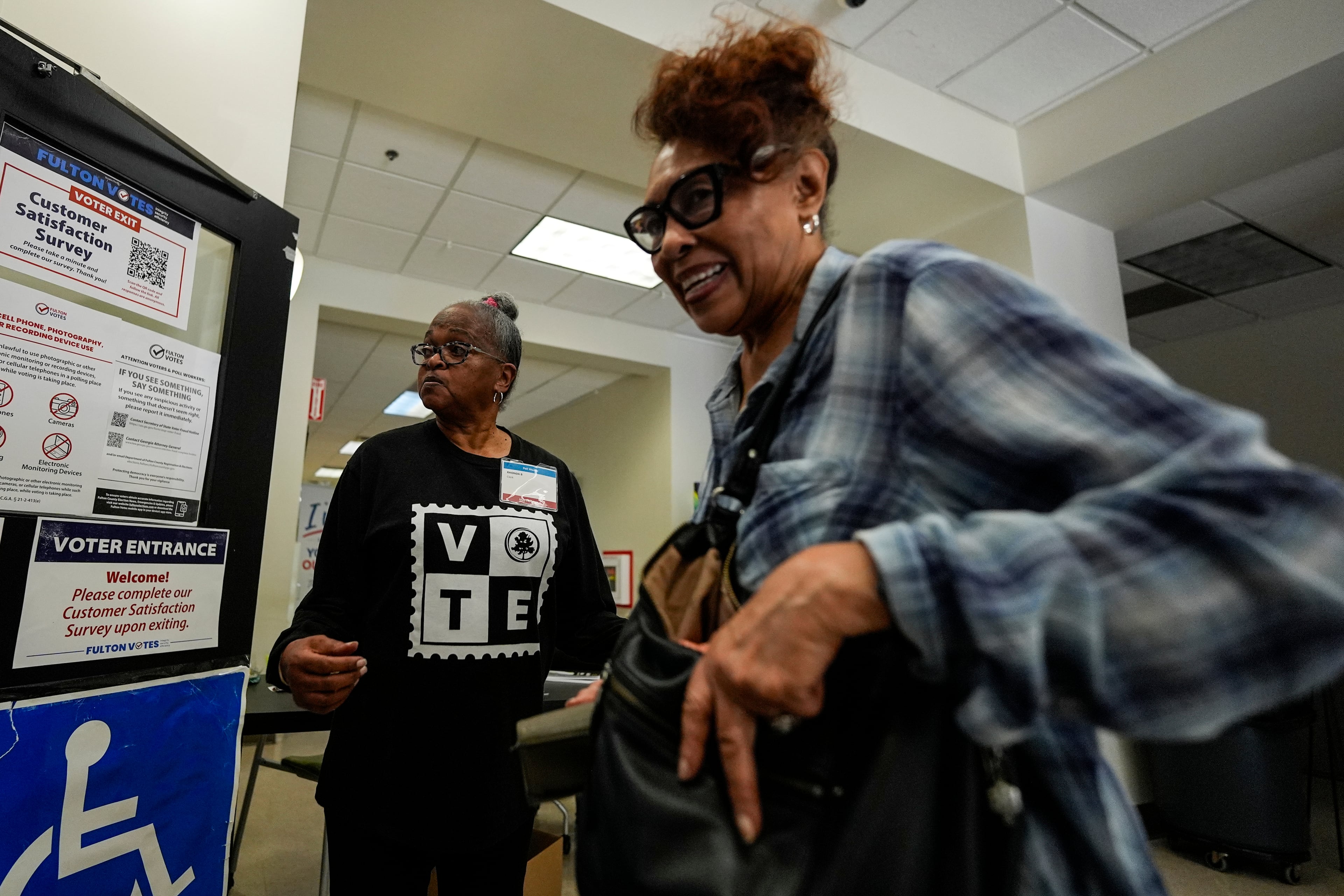 A voter enters the Southwest Arts Center voting site on the first day for early voting in Georgia, Tuesday in Atlanta. (Mike Stewart/AP)