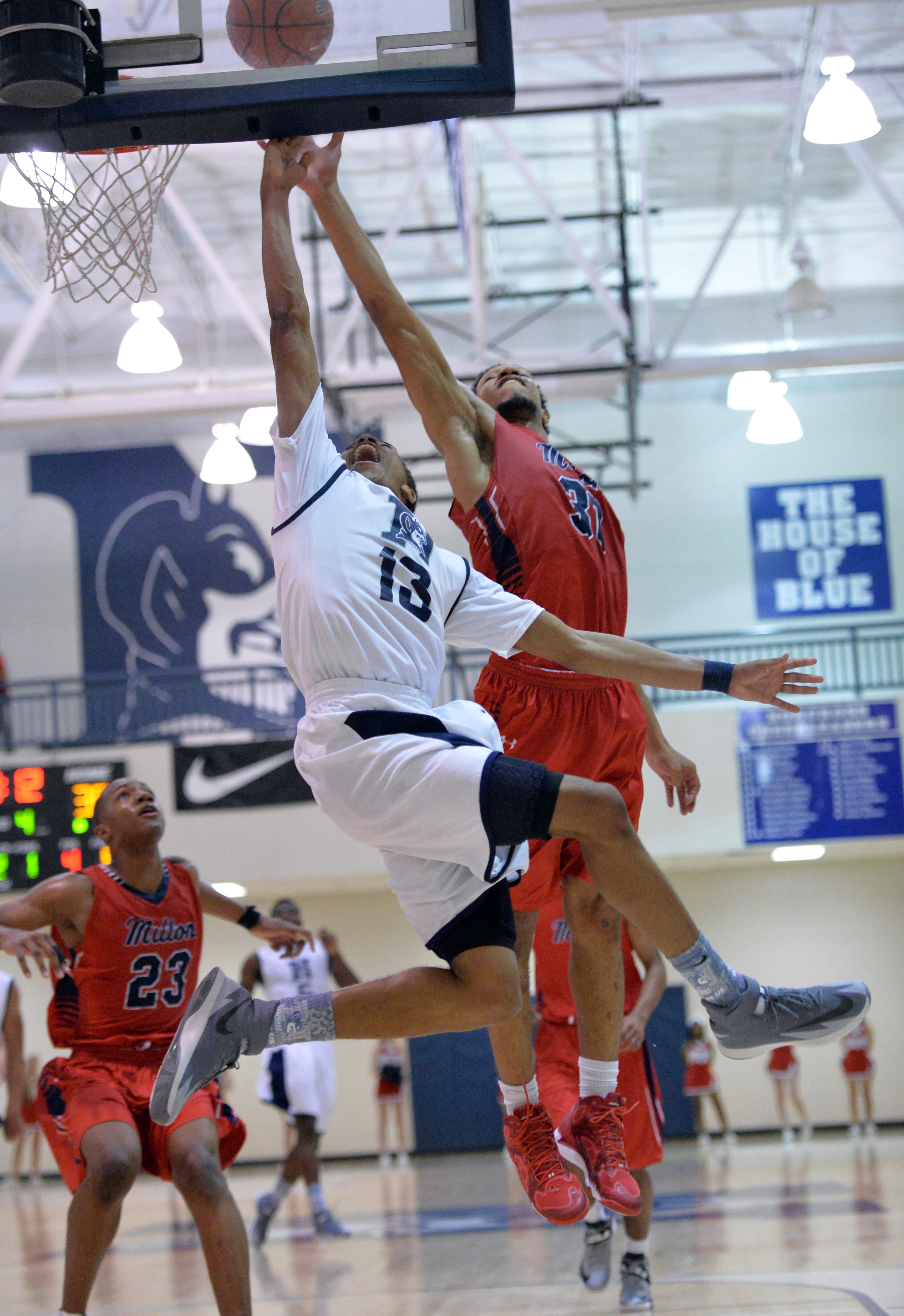 Norcross' Andre Chatfield (13) shoots against Milton' Mo Lewis IV (30) in the second half of 1st Round of State AAAAAA Playoffs at Norcross High School in Norcross on Saturday, February 22, 2014. Norcross won 49-36 over the Milton.