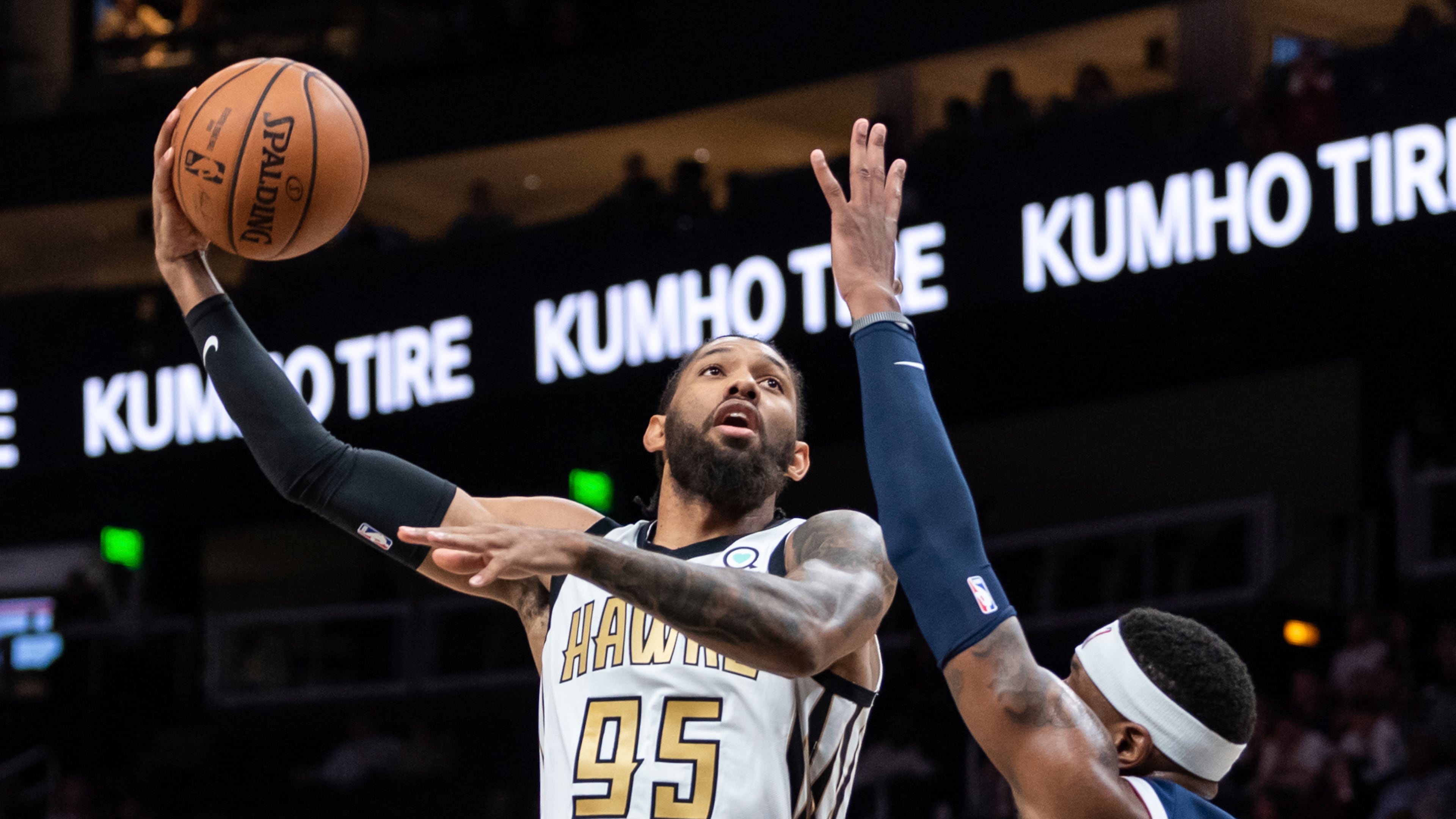 Atlanta Hawks forward DeAndre' Bembry (95) shoots the ball as Denver Nuggets forward Torrey Craig defends during the first half of an NBA basketball game Saturday, Dec. 8, 2018, in Atlanta. (AP Photo/Danny Karnik)