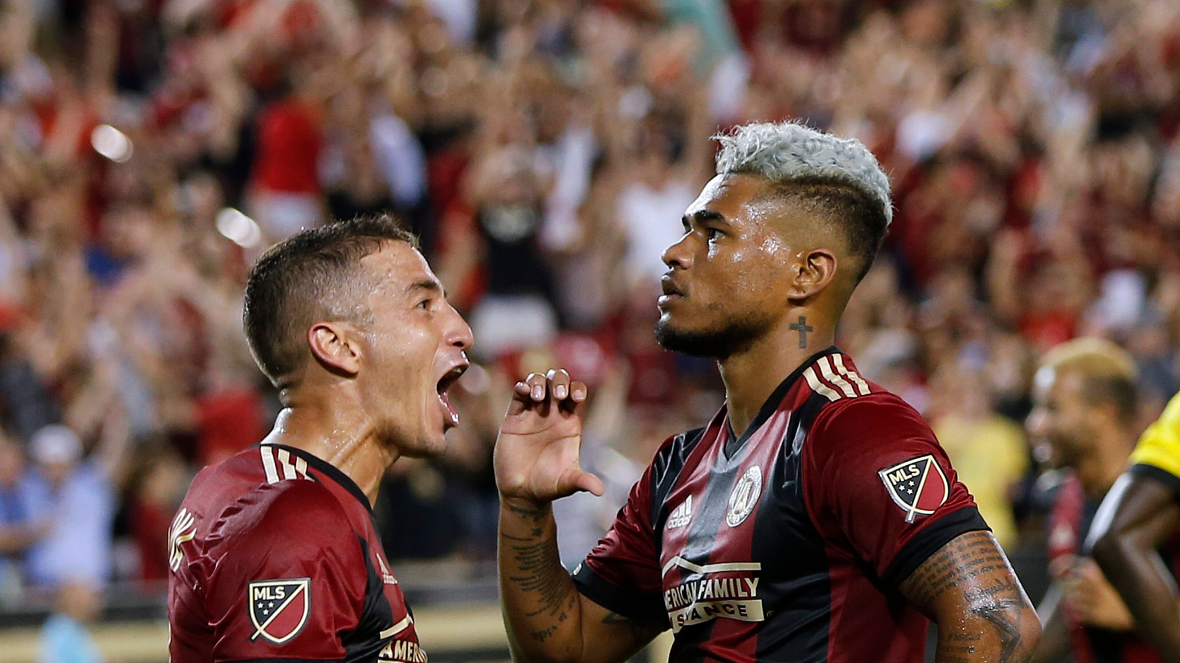 Atlanta United forward Josef Martinez (7) celebrates with midfielder Carlos Carmona (14) after scoring a goal in the second half of an MLS soccer match against the Columbus Crew, Saturday, June 17, 2017, in Atlanta . Atlanta won 3-1. (AP Photo/John Bazemore)