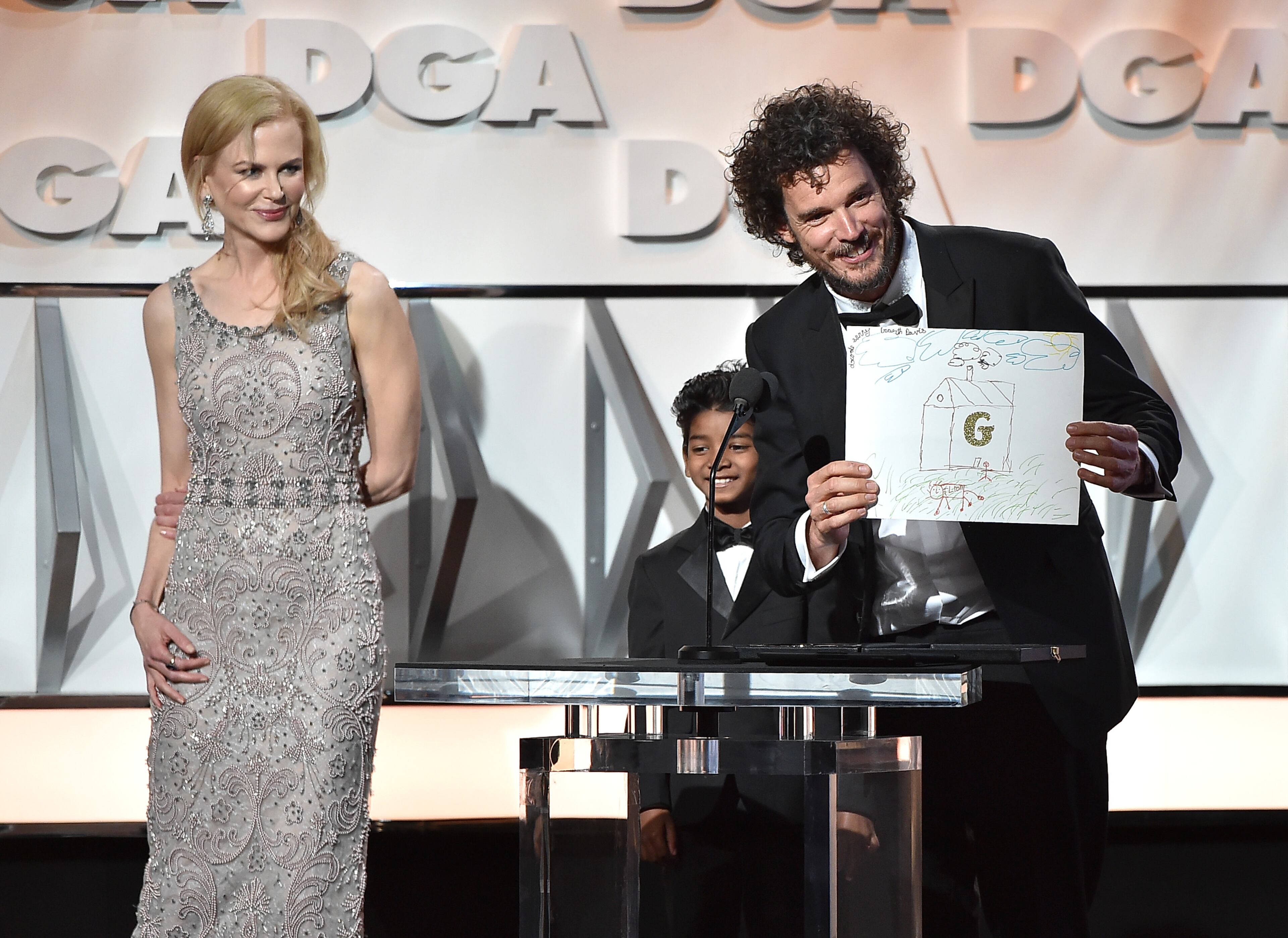 BEVERLY HILLS, CA - FEBRUARY 04: (L-R) Actors Nicole Kidman and Sunny Pawar present the Feature Film Nomination Plaque for “Lion” to director Garth Davis onstage during the 69th Annual Directors Guild of America Awards at The Beverly Hilton Hotel on February 4, 2017 in Beverly Hills, California. (Photo by Alberto E. Rodriguez/Getty Images for DGA)