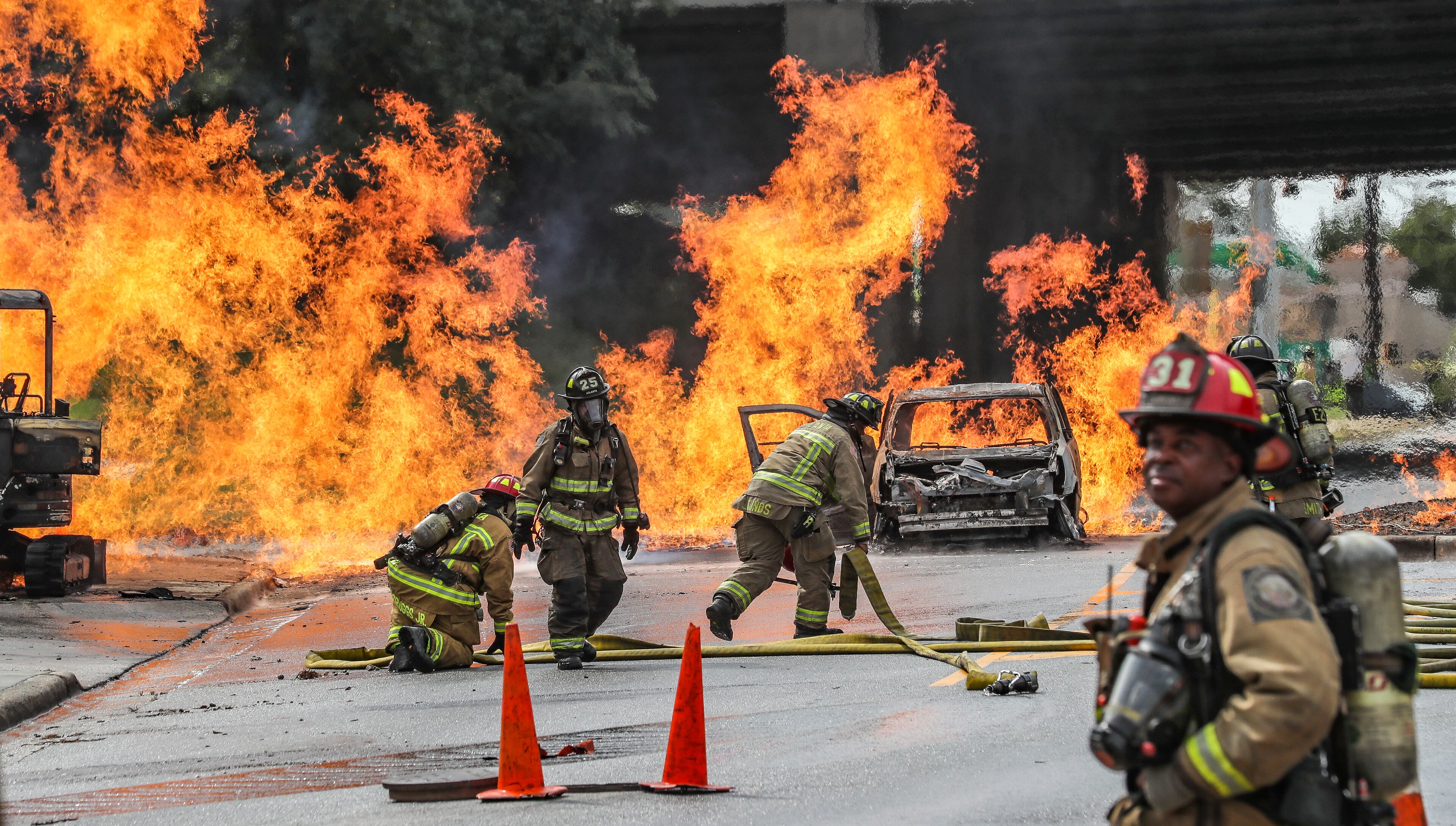 Firefighters continued to battle a massive gas fire in southwest Atlanta on Wednesday morning, Sept. 20, 2023, that shut down several roads, including a major highway. The blaze was reported around 10:45 a.m. at 2049 Sylvan Road near the entrance to Langford Parkway in the Sylvan Hills neighborhood. (John Spink / John.Spink@ajc.com)