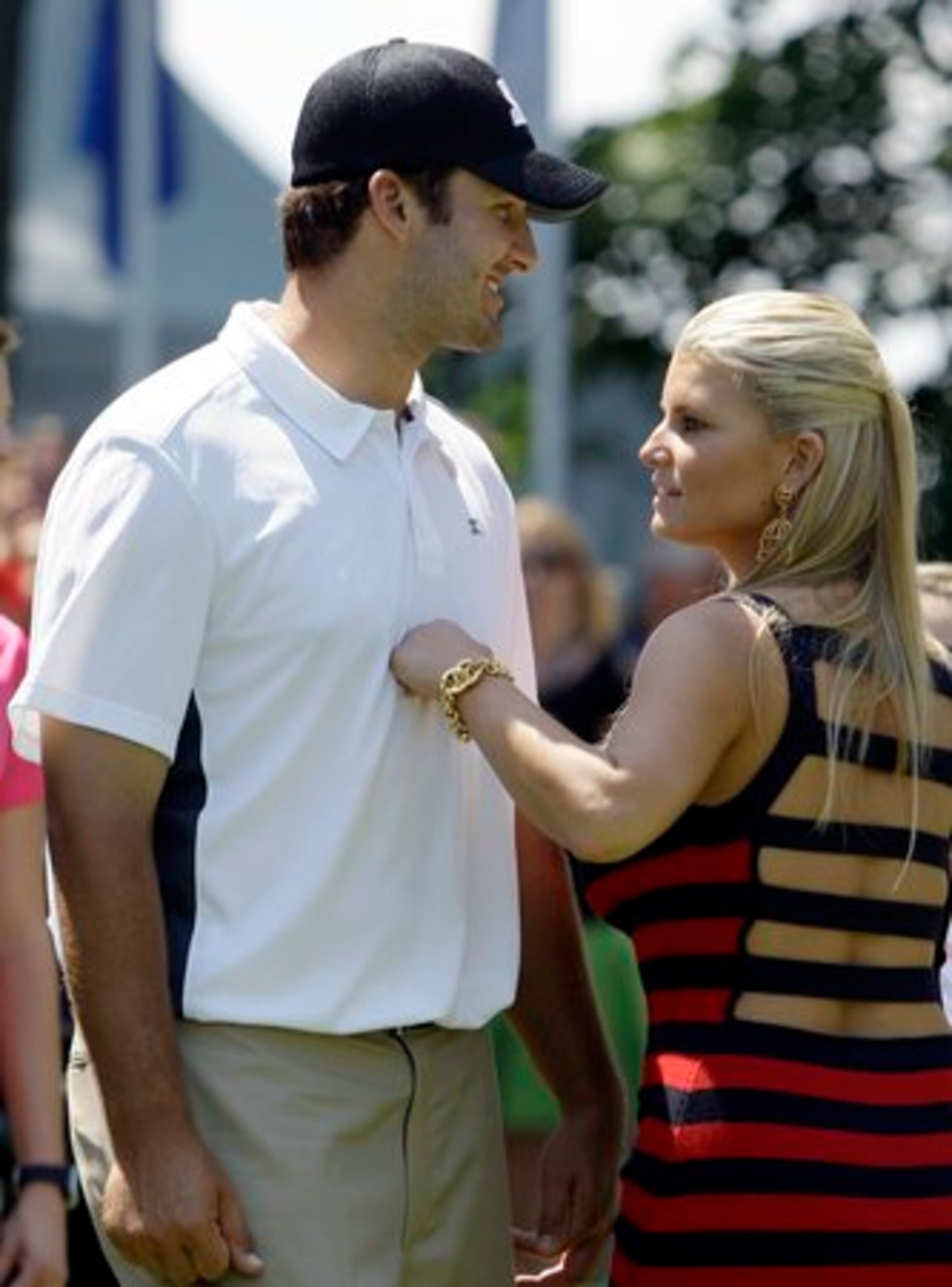 FIST-CHEST BUMP: Celeb Jessica Simpson and her boyfriend, Dallas Cowboys quarterback Tony Romo, on the first tee Wednesday at the AT&T National golf tournament at Congressional Country Club in Bethesda, Md.