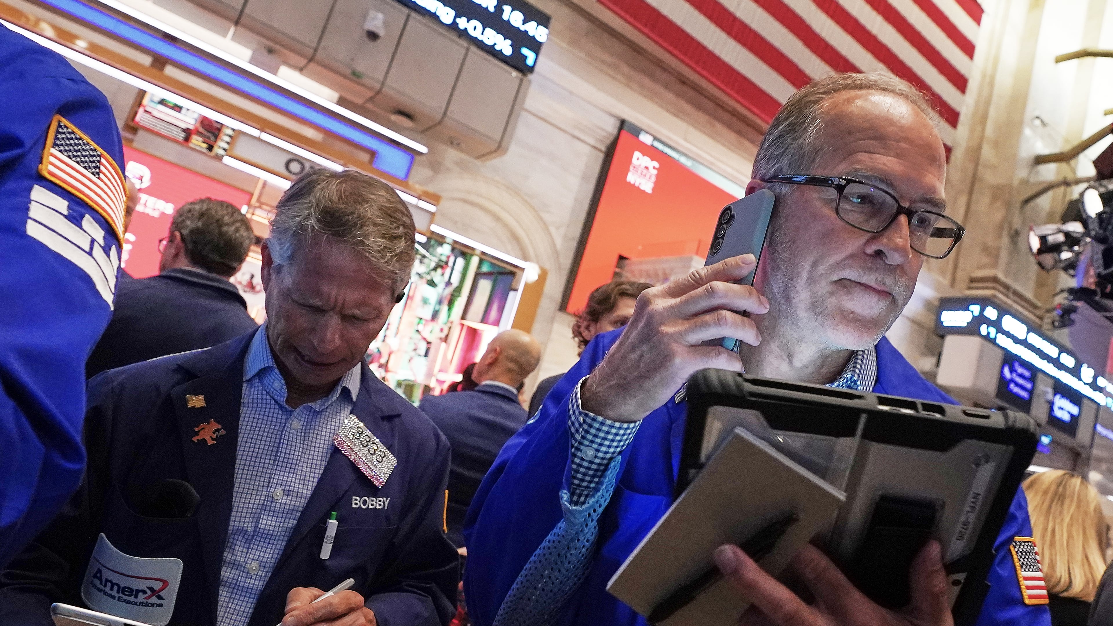 Traders Robert Charmak, left, and Mark Puetzer work on the floor of the New York Stock Exchange, Thursday, June 25, 2026. (AP Photo/Richard Drew)