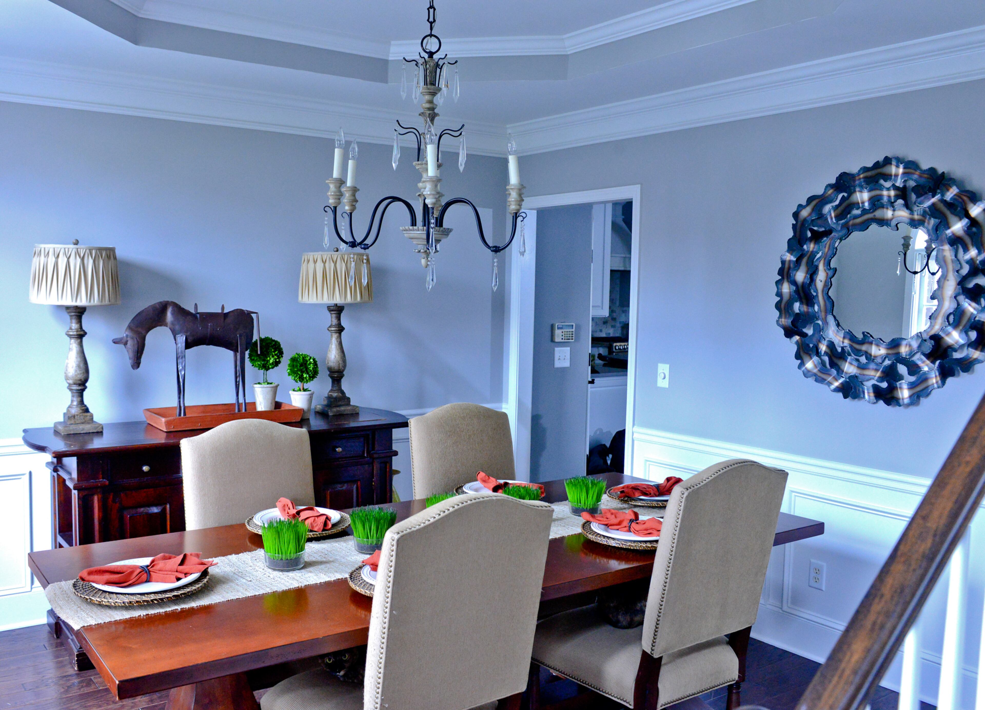 Natural light streams into Stephanie and Ken Wright's Cumming dining room, where the walls are painted in Sherwin-Williams Silverplate and a tray ceiling and traditional chandelier add dimension.