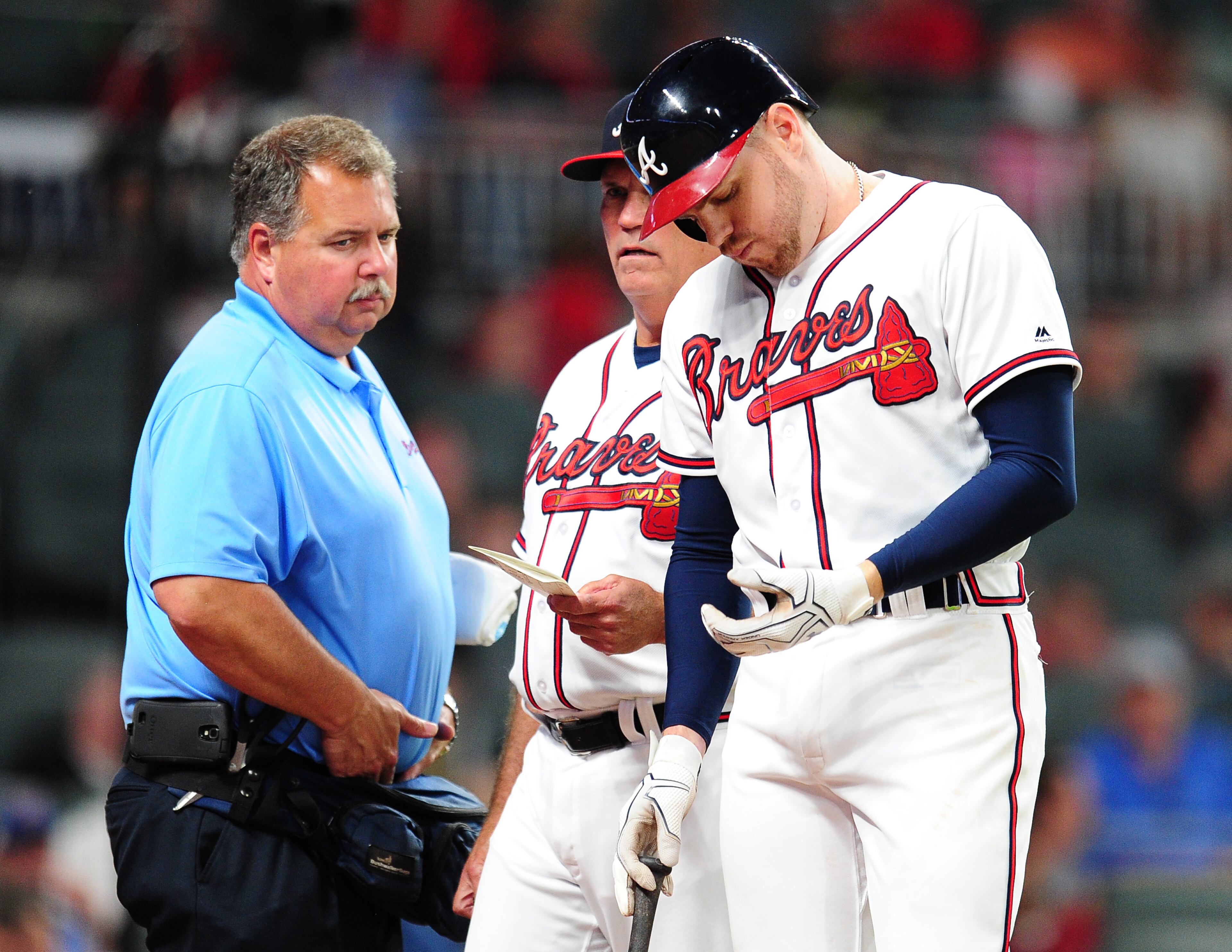 ATLANTA, GA - MAY 17: Freddie Freeman #5 of the Atlanta Braves is removed by Manager Brian Snitker #43 as trainer Jim Lovell watches after being hit by a fifth inning pitch against the Toronto Blue Jays at SunTrust Park on May 17, 2017 in Atlanta, Georgia. (Photo by Scott Cunningham/Getty Images)