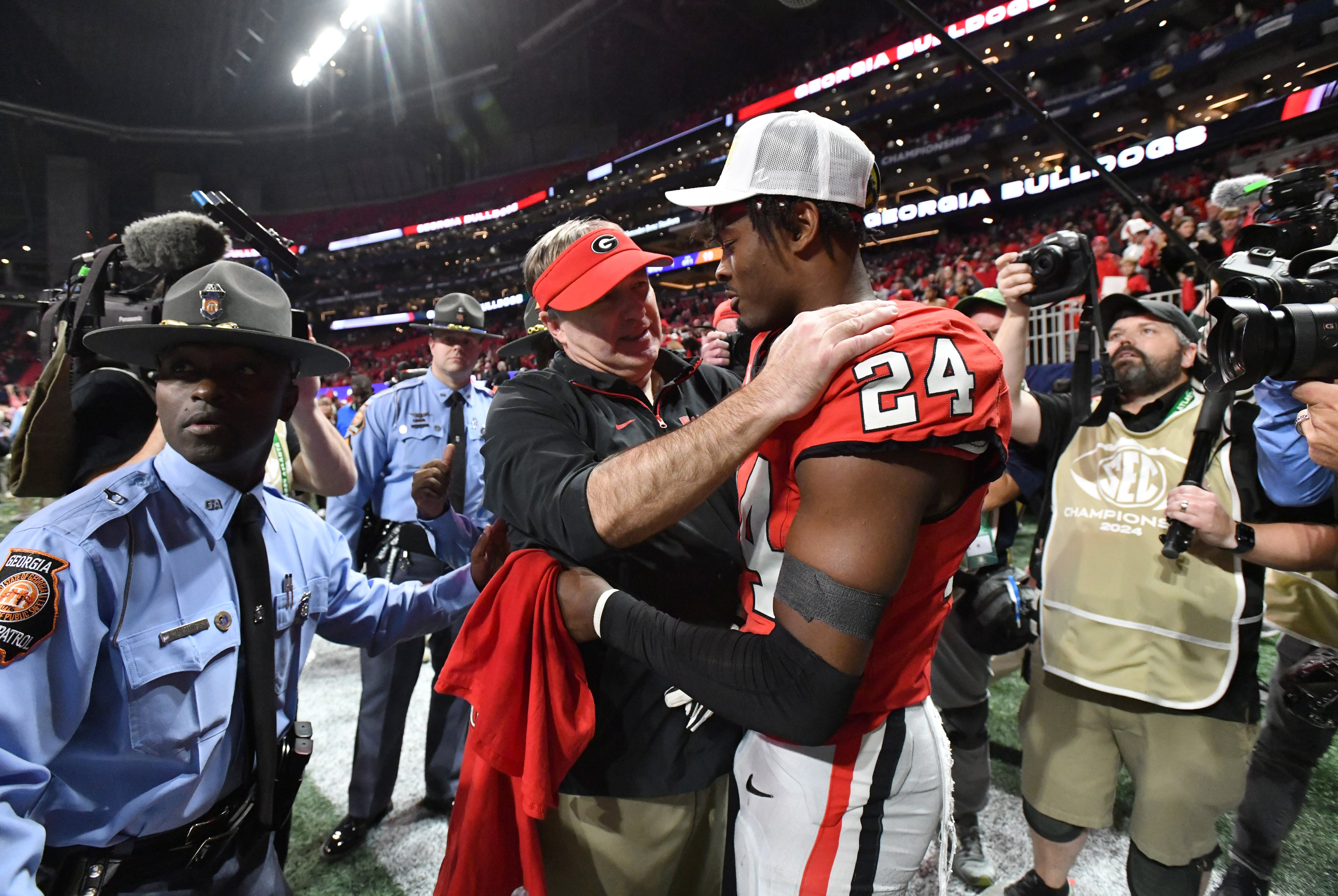 Georgia head coach Kirby Smart congratulates Georgia defensive back Malaki Starks (24) after beatingTexas in overtime during the SEC Championship football game at the Mercedes-Benz Stadium, Saturday, December 7, 2024, in Atlanta. Georgia won 22-19 over Texas in overtime. (Hyosub Shin / AJC)
