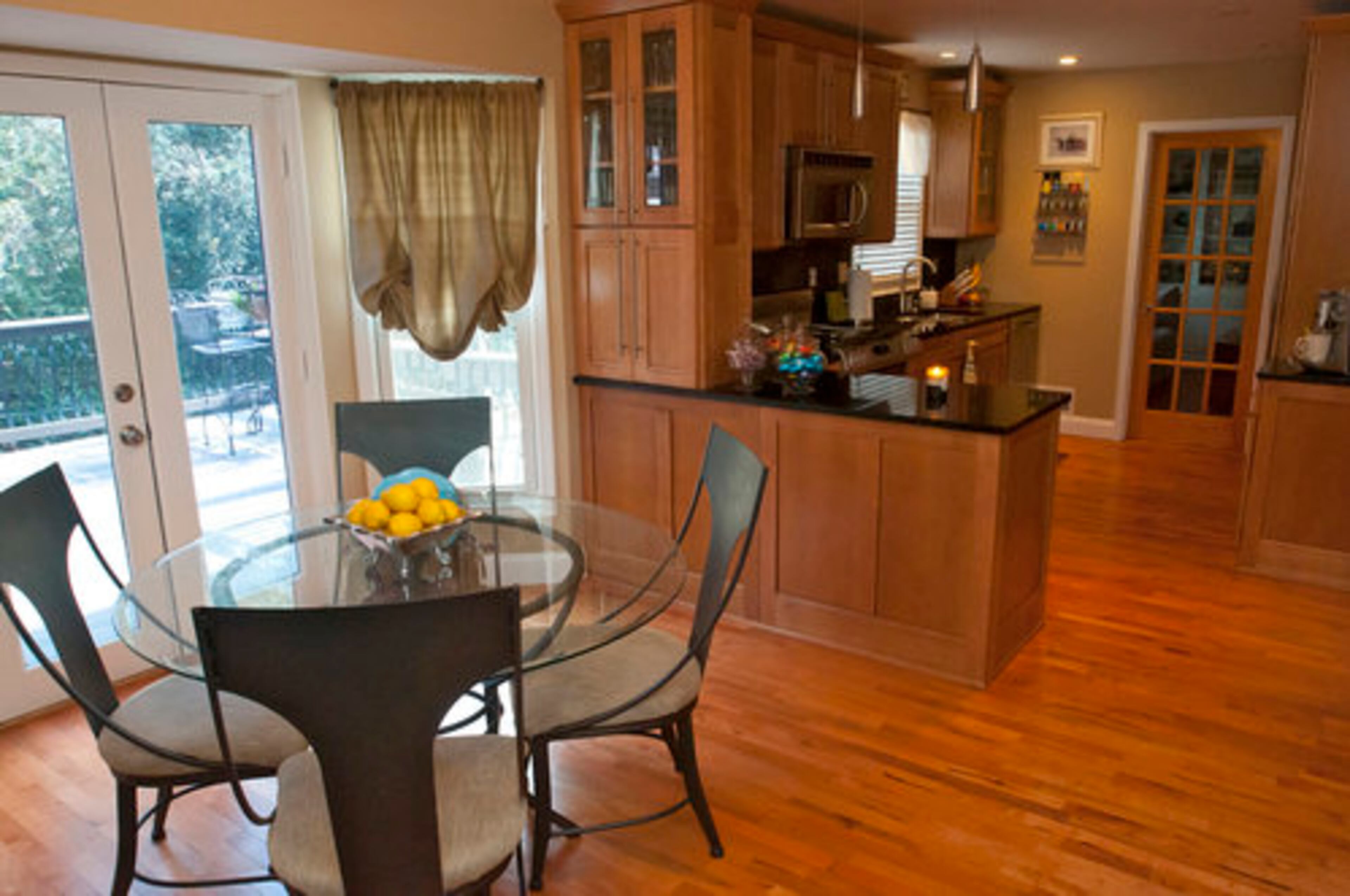 The kitchen of the Shapiros' house leads directly to the breakfast nook. They purchased and installed the hanging lights. We thought that they had a nice elegant, modern feel to them and they are LED, which make them energy efficient, Vanessa Shapiro said.