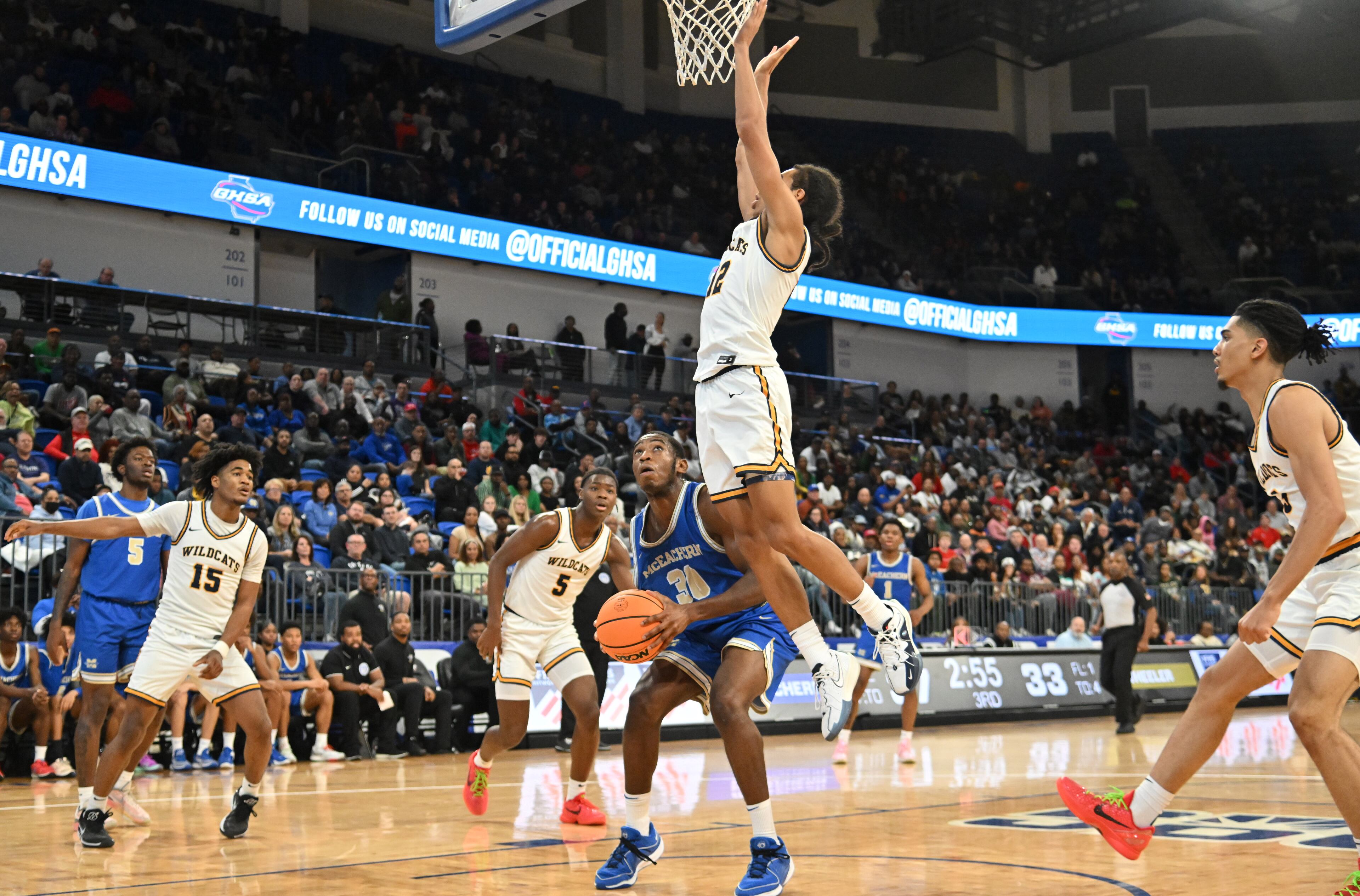 McEachern's Nnadozie Onyirimba (30) prepares to shoot against Wheeler's Kevin Savage (12) during the second half of GHSA Class 7A Semifinal basketball game at GSU’s Convocation Center, Saturday, Mar. 2, 2024, in Atlanta. (Hyosub Shin / Hyosub.Shin@ajc.com)