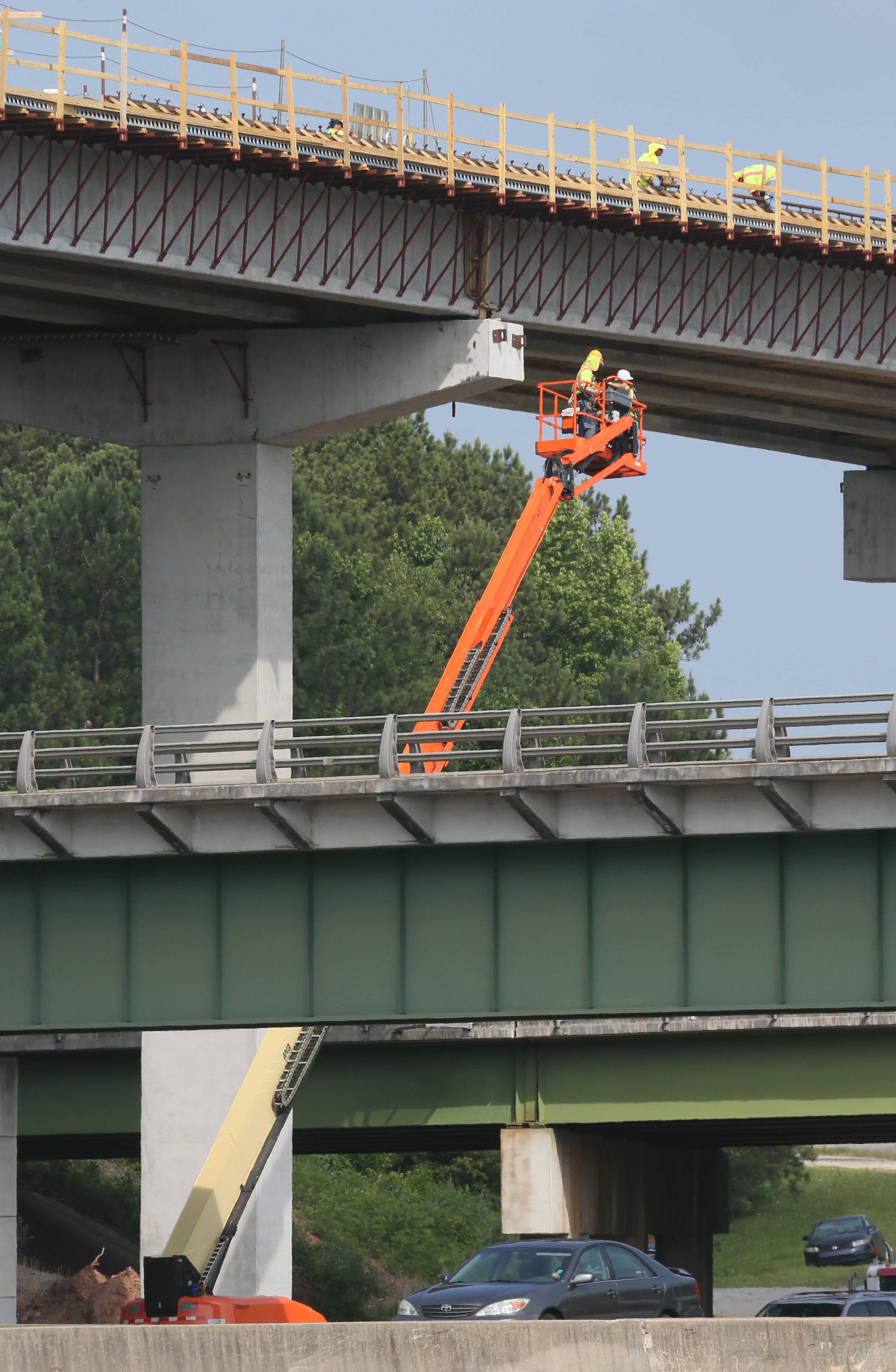 This view shows the express lane bridge over the Canton Road Connector. I-75 southbound is at the bottom, and in the middle is a railroad bridge which runs parallel to the Canton Road Connector overpass behind it. BOB ANDRES / BANDRES@AJC.COM
