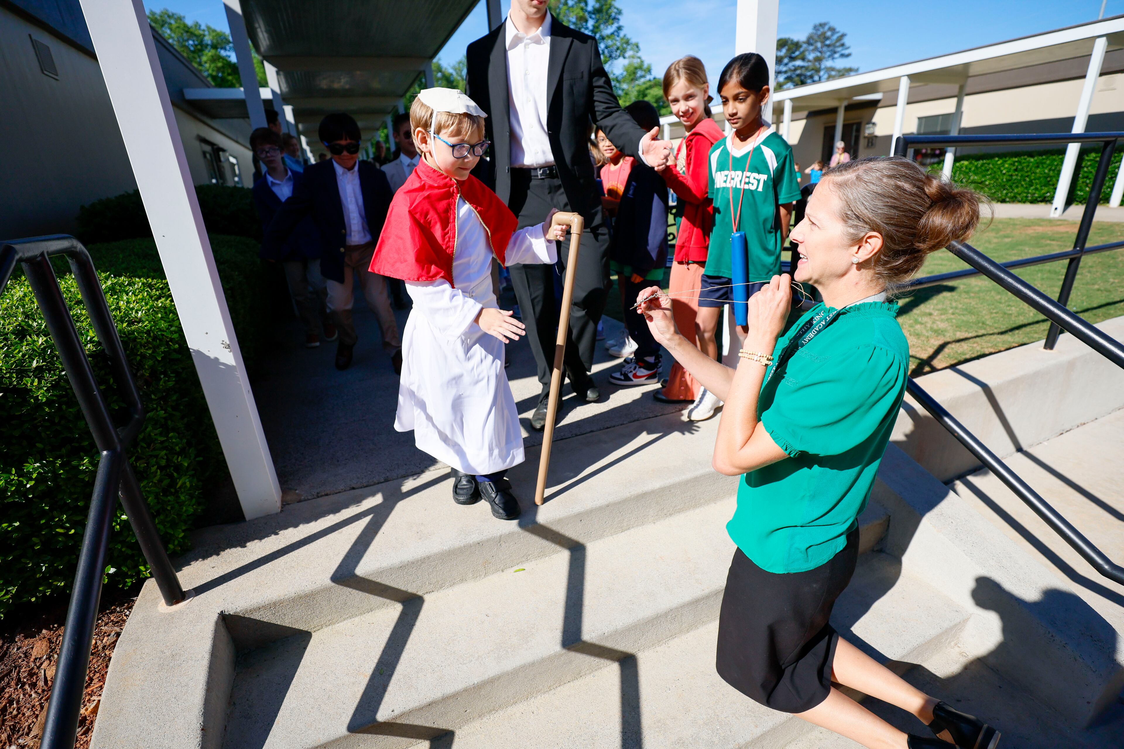 Sarah Gagnier, lower and middle school Director, offered a cross to the newly elected Pope David during a mock papal conclave at Pinecrest Academy on Tuesday, May 6, 2025. This activity was designed to help participants learn about the process in an engaging way.
(Miguel Martinez/ AJC)