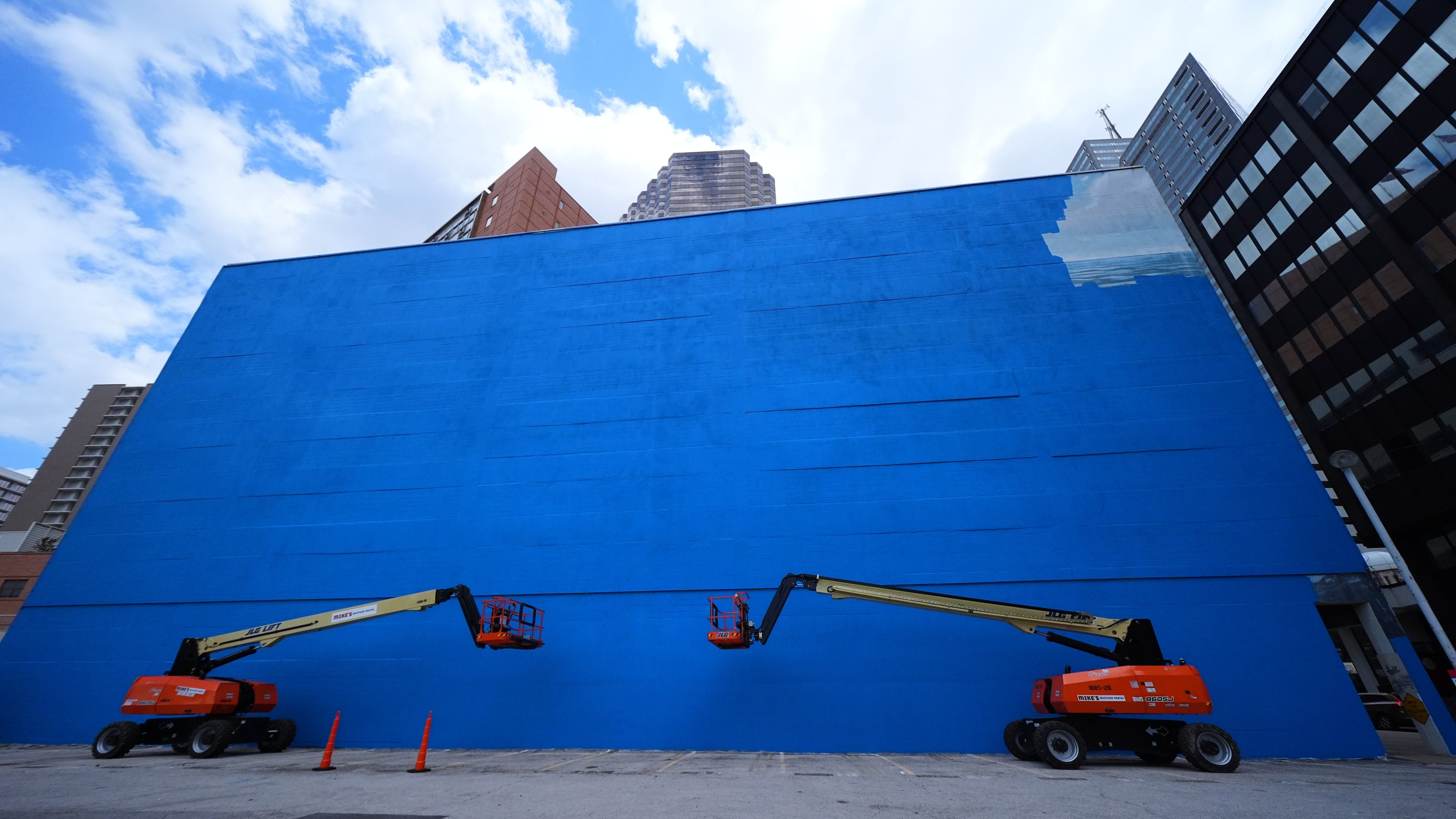 A mural, known as the "Whaling Wall 82," created by artist Wyland, is partially visible as it is painted over, Monday, May 18, 2026, in Dallas. (AP Photo/Julio Cortez) CORRECTION: Corrects to mural being painted over