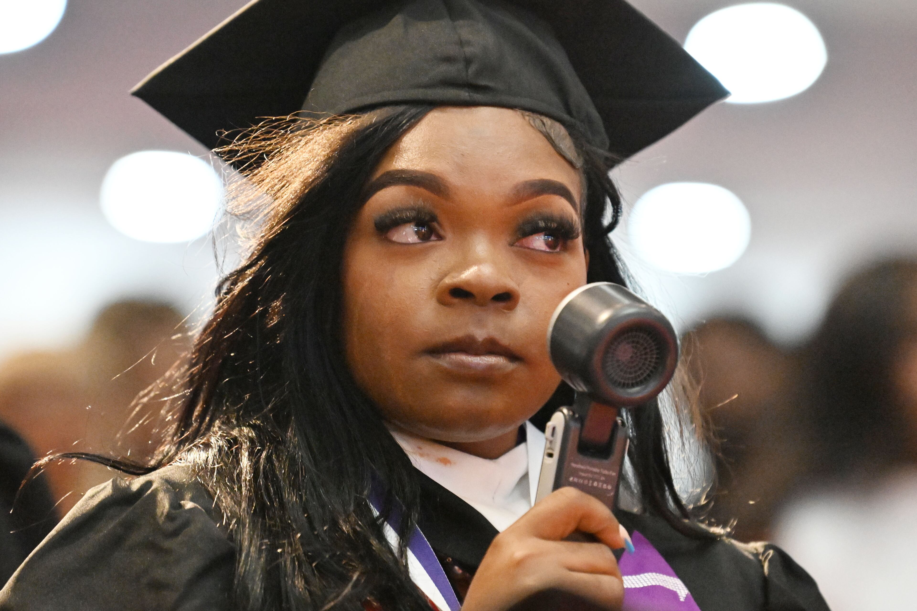 Graduates react as Bishop T.D. Jakes delivers a commencement address during 2025 Morris Brown College commencement exercises at Saint Philip A.M.E. Church, Saturday, May 17, 2025, in Atlanta. (Hyosub Shin / AJC)