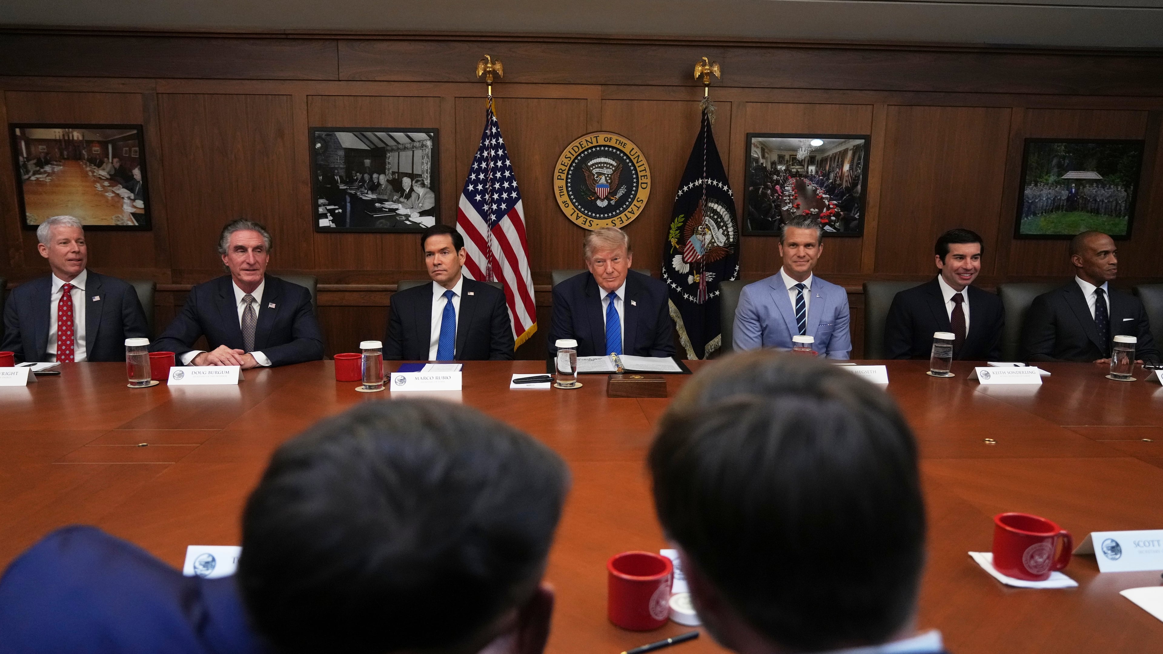 President Donald Trump, seated center, joined by Energy Secretary Chris Wright, from left, Interior Secretary Doug Burgum, Secretary of State Marco Rubio, Defense Secretary Pete Hegseth, acting Labor Secretary Keith Sonderling, and Housing and Urban Development Secretary Scott Turner, attends a cabinet meeting, Friday, July 31, 2026, at Camp David, the presidential retreat, near Thurmont, Md., Friday, July 31, 2026. (AP Photo/Jacquelyn Martin)