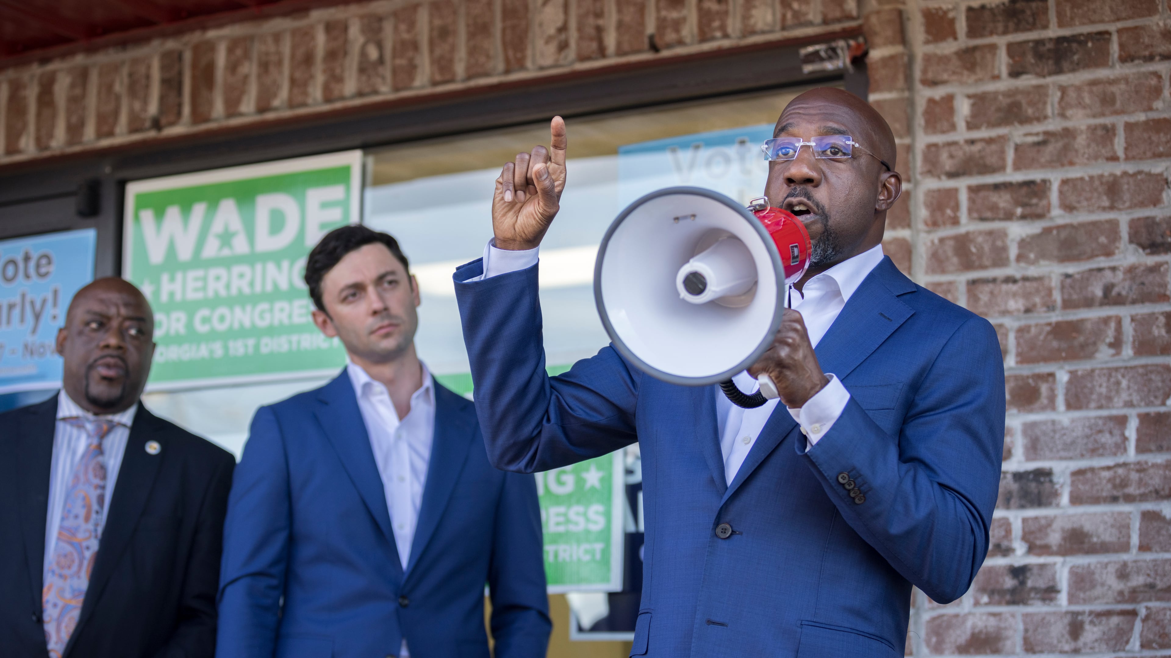 SAVANNAH, GA - OCTOBER 25, 2022: Georgia Democratic Senate candidate Raphael Warnock, right, Sen. Jon Ossoff (D-Ga), center, and Savannah Mayor Van Johnson, left, meet with supporters in front of a canvassing office Tuesday, Oct. 25, 2022, in Savannah, Ga. Ossify and Warnock spoke to supporters who where about to canvass neighborhoods in the area. (AJC Photo/Stephen B. Morton)