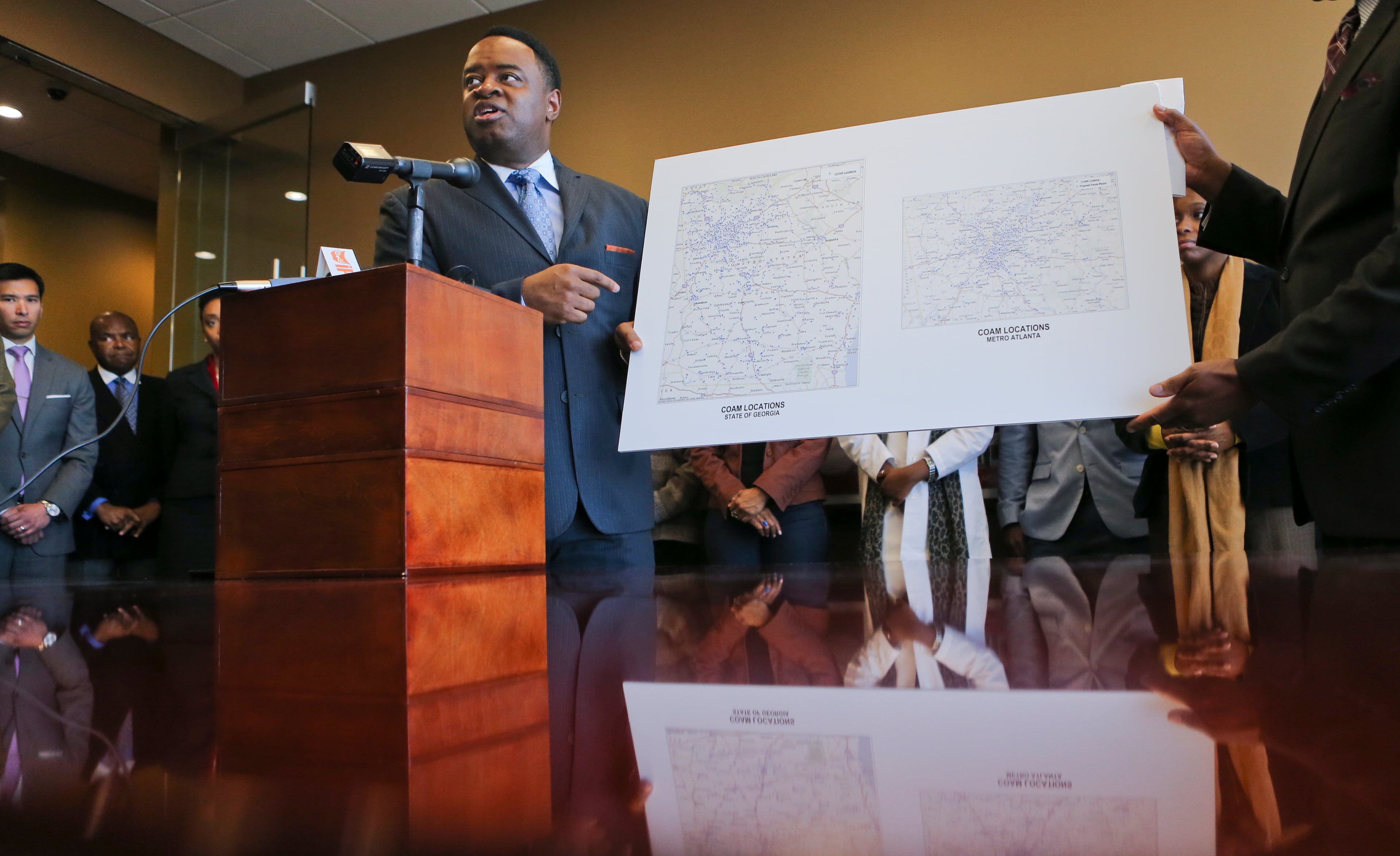 An Atlanta Journal-Constitution/Channel 2 Action News investigation revealed that an invalid, possibly forged legal document allowed a government official to double as a government contractor, despite ethics rules to the contrary. Vaughn Irons (shown in February 2015), chairman of DeKalb’s Development Authority, won a $1 million contract to rehab and sell foreclosed homes. Irons has said he had nothing to do with the document and that he even passed a lie detector test clearing him of wrongdoing. The District Attorney’s office is reviewing the matter. -- Text by AJC staff reporters