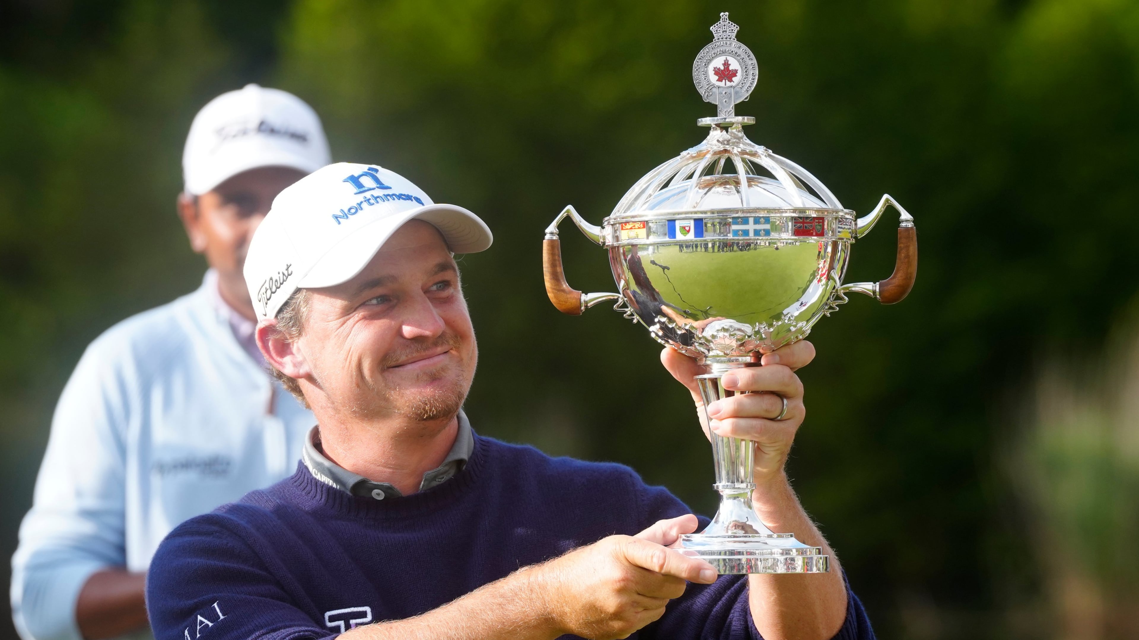 Bud Cauley, of the United States, holds the trophy after winning the Canadian Open golf tournament in Caledon, Ontario, Sunday June 14, 2026. (Frank Gunn/The Canadian Press via AP)