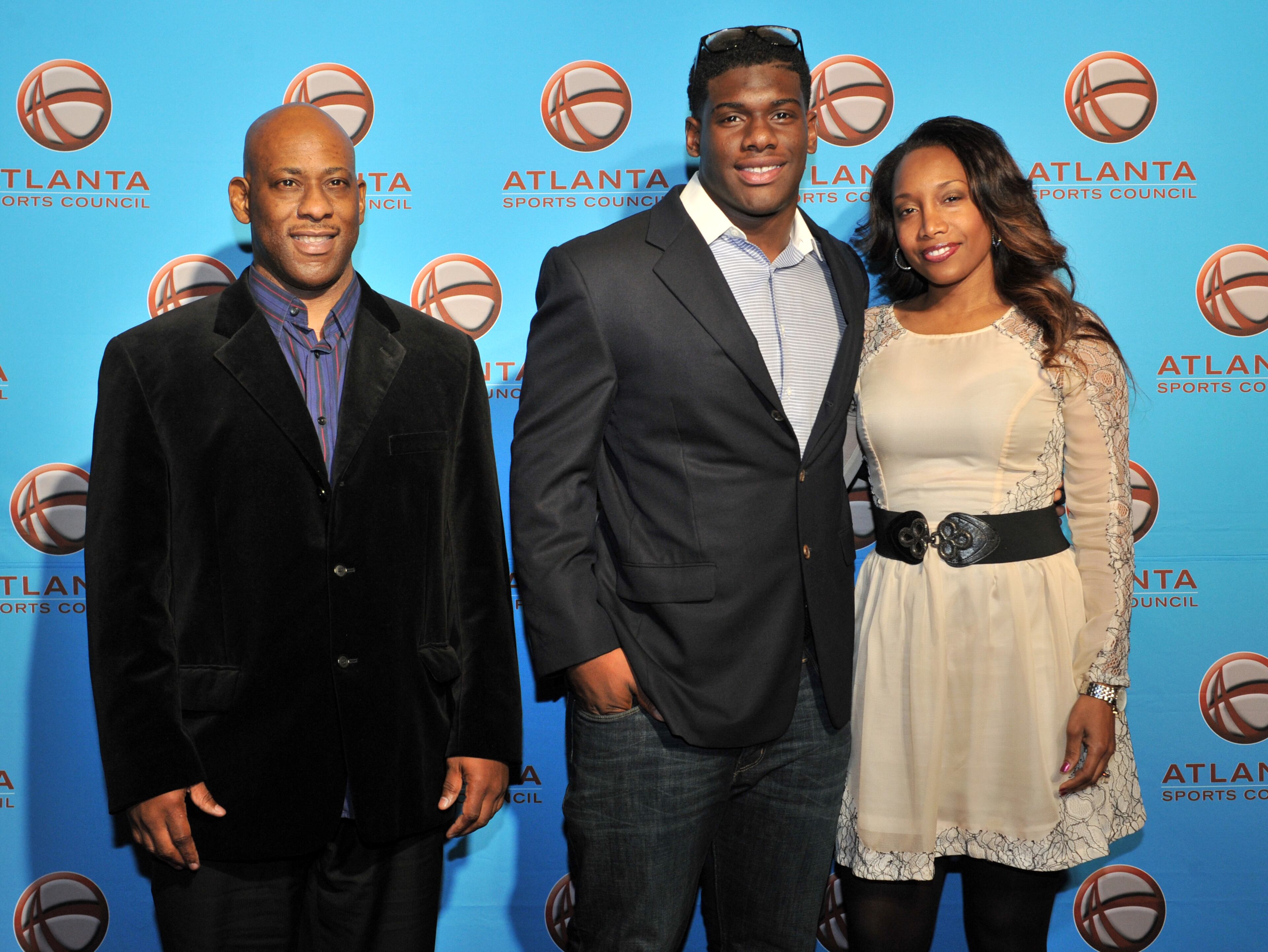 ESPN ranks Milton High School defensive end Carl Lawson (center), who is committed to Auburn, and his parents Carl Lawson Sr. and Mignon Clark arrive on the red carpet.