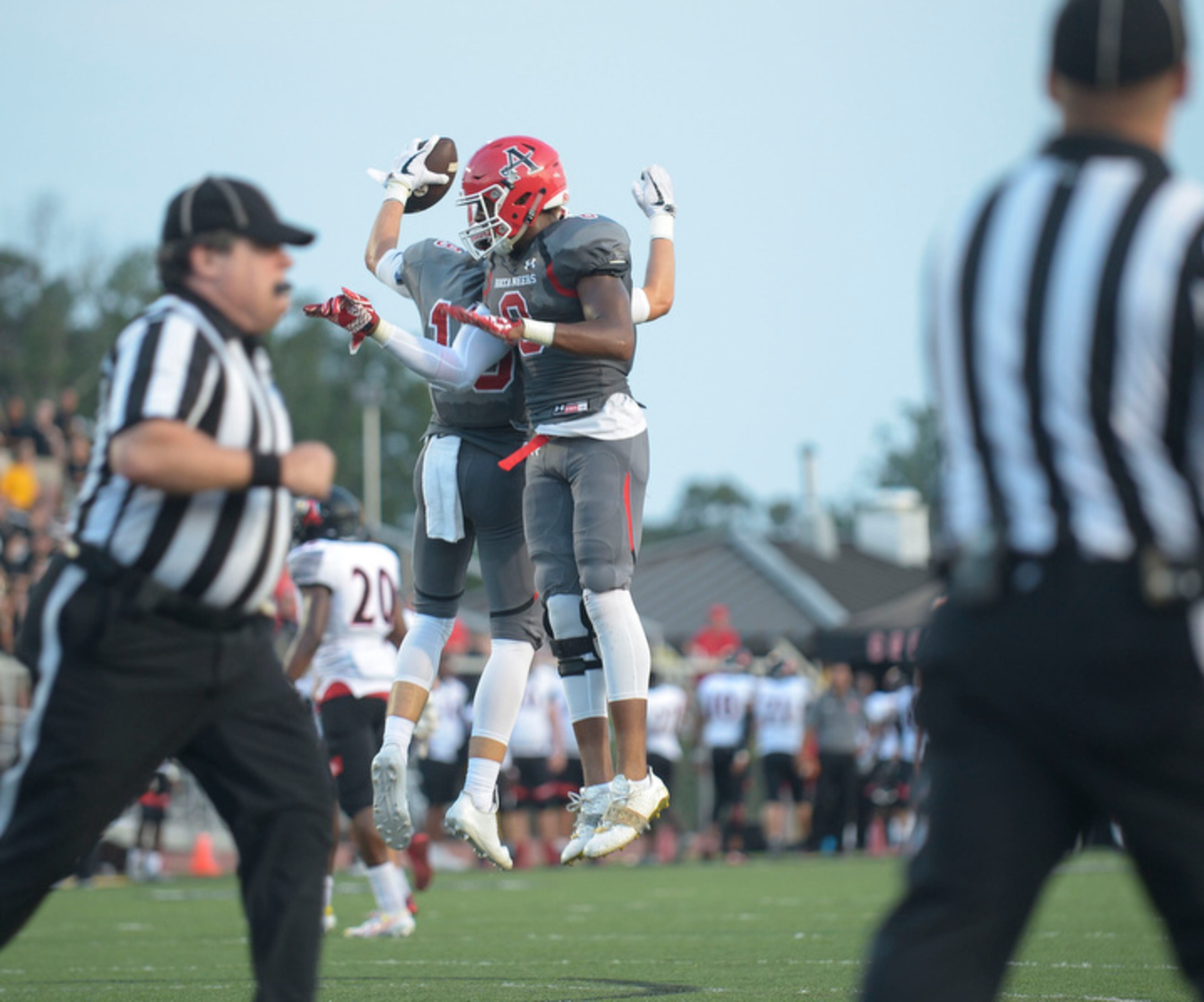Allatoona junior WR Dawson Coltran (19) celebrates his touchdown early in the second quarter with junior DE Jaylan Willams (8) during their game against Alexander Friday, August 25, 2017.