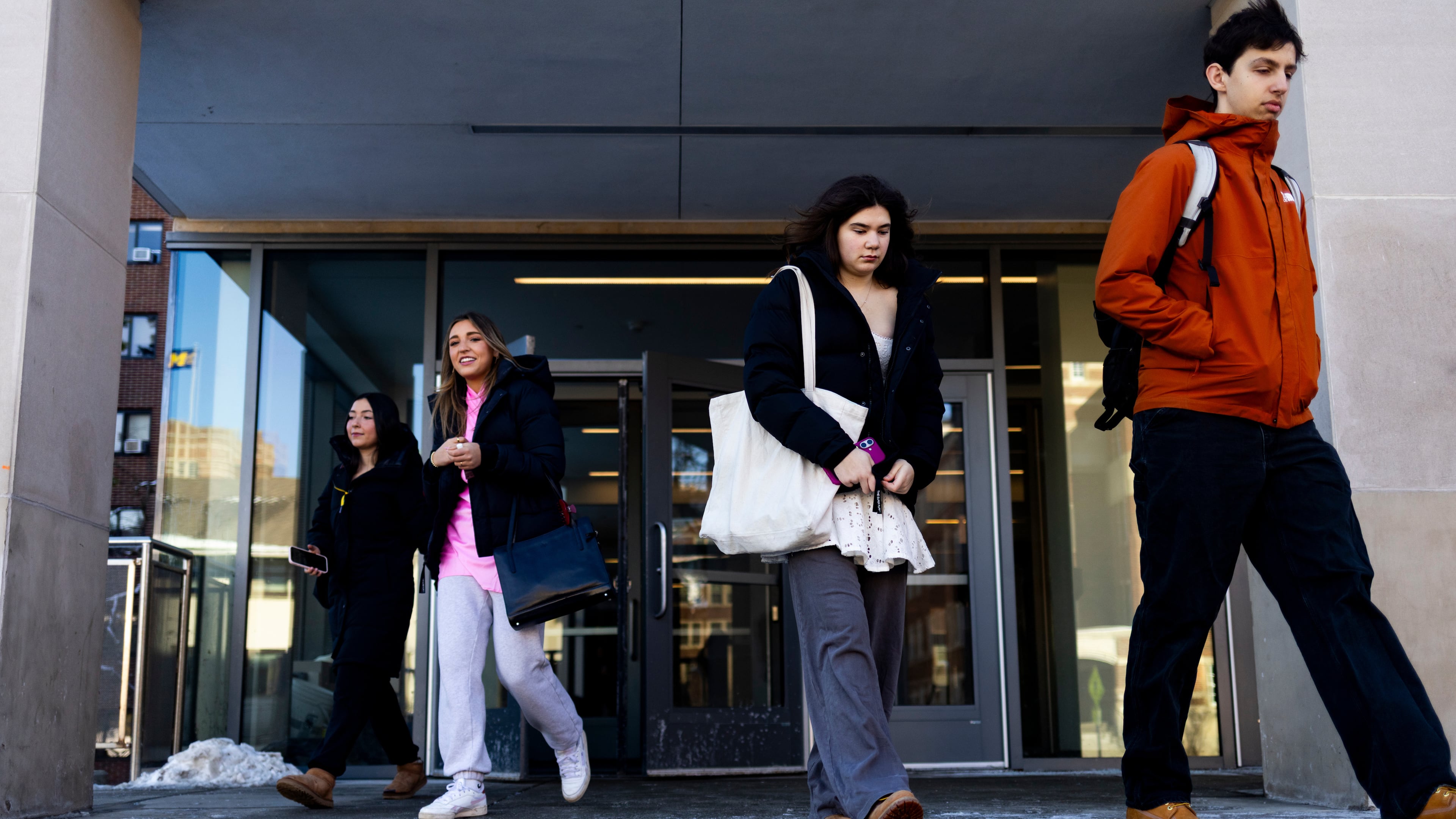 Students walk out of South Quad on the University of Michigan campus in Ann Arbor, Mich., Jan. 17, 2026. (AP Photo/Emily Elconin)