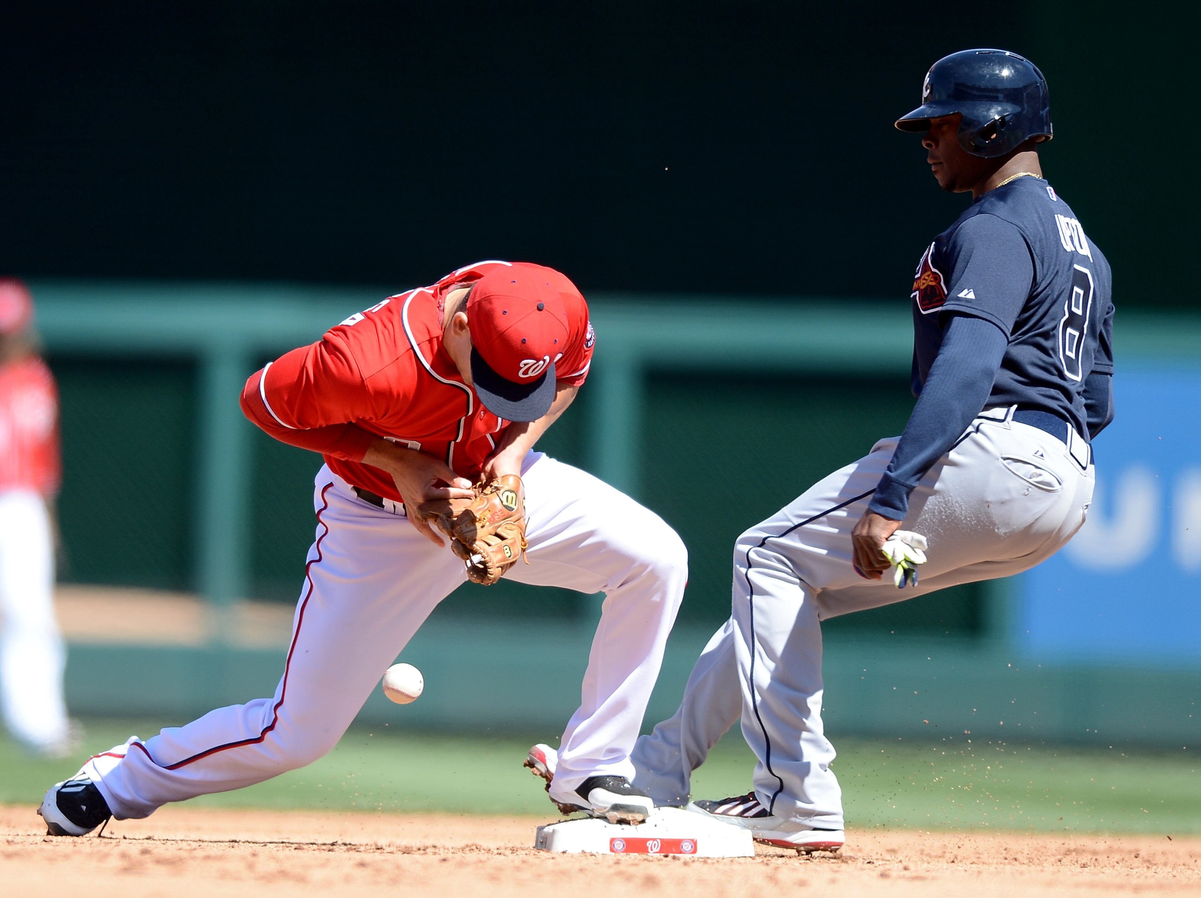Washington Nationals second baseman Danny Espinosa (8) drops a throw and commits an error, allowing Atlanta Braves left fielder Justin Upton (8) to reach second base safely in the fourth inning at Nationals Park in Washington, D.C., Sunday, April 6, 2014. (Chuck Myers/MCT)