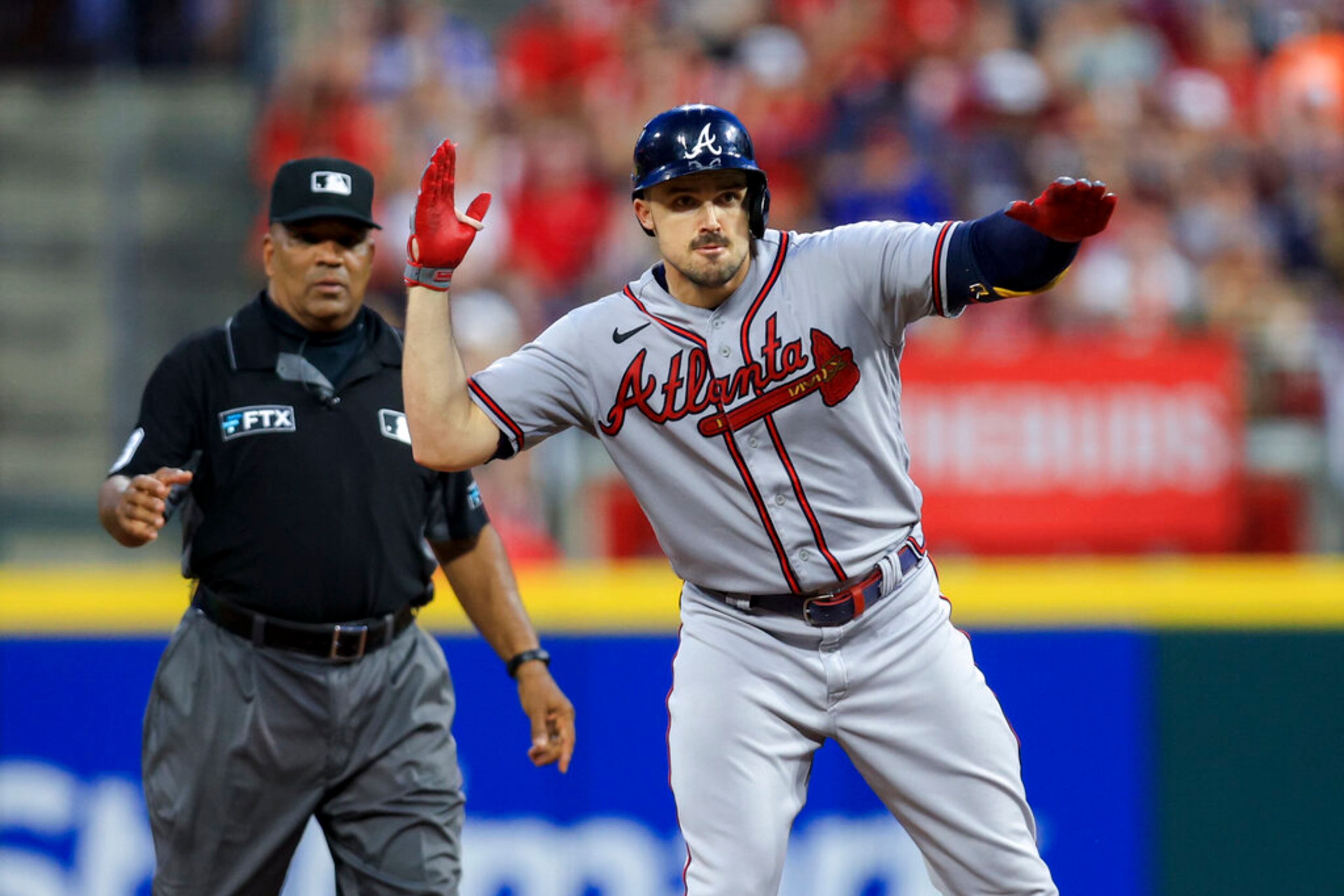 Atlanta Braves' Adam Duvall gestures after hitting an RBI double during the eighth inning of the team's baseball game against the Cincinnati Reds in Cincinnati, Friday, July 1, 2022. The Braves won 9-1. (AP Photo/Aaron Doster)