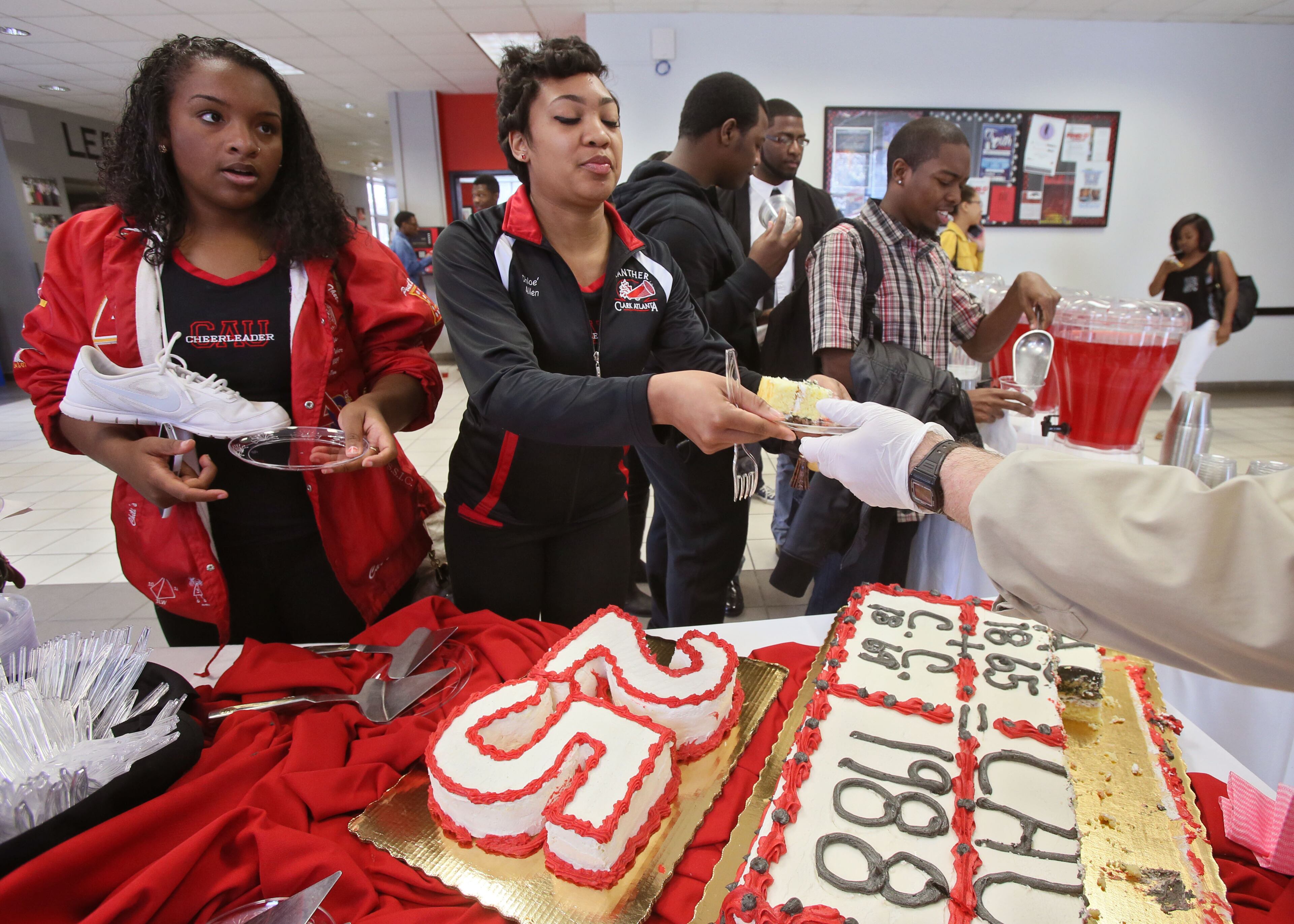 March 21, 2014 - Atlanta - Students line up in the Student Center for a piece of anniversary cake. Clark Atlanta University celebrated its 25th anniversary with a rally on the Henderson Promenade, one of several Founders Week events, which will conclude with a songfest and gala this weekend. The rally included a performance by the Mighty Marching Panthers Drum line, the CAU cheerleaders, speakers, and a 25th anniversary cake. The event celebrates the 25th anniversary of the consolidation of its parent institutions, Atlanta University (founded in 1865) and Clark College (founded in 1869). BOB ANDRES / BANDRES@AJC.COM