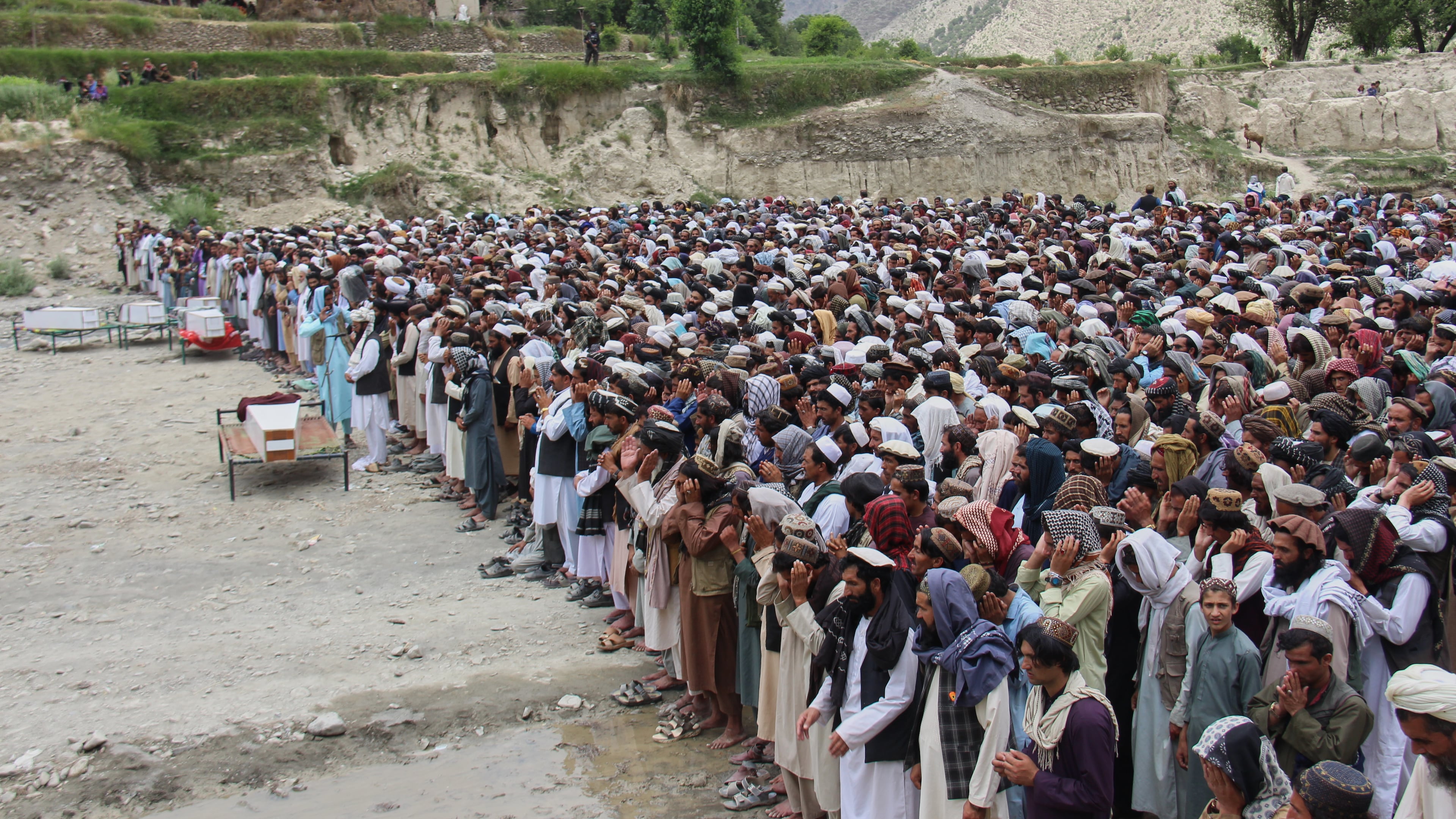 Mourners pray during a funeral for victims, including children, of airstrikes that Taliban officials said were carried out by Pakistan, in Mana, a village in Afghanistan's Khost province, Wednesday, June 10, 2026. (AP Photo/Saifullah Zahir)