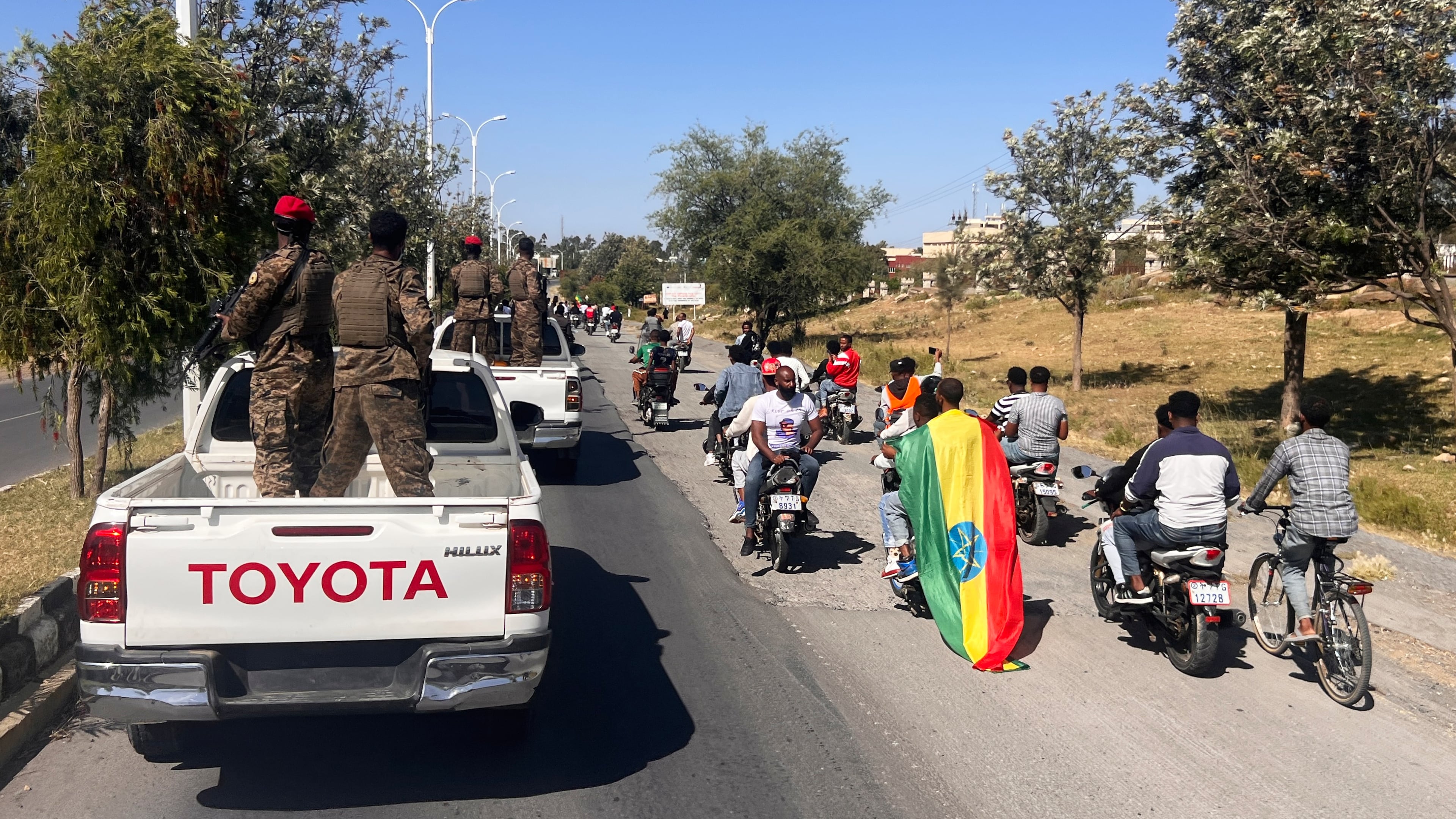 In this photo taken with a smartphone, supporters and soldiers participate in a procession welcoming former Tigray leader Getachew Reda in Mekelle, Ethiopia, Sunday, Oct. 11, 2026. (AP Photo/Filmon Equar Hailu)