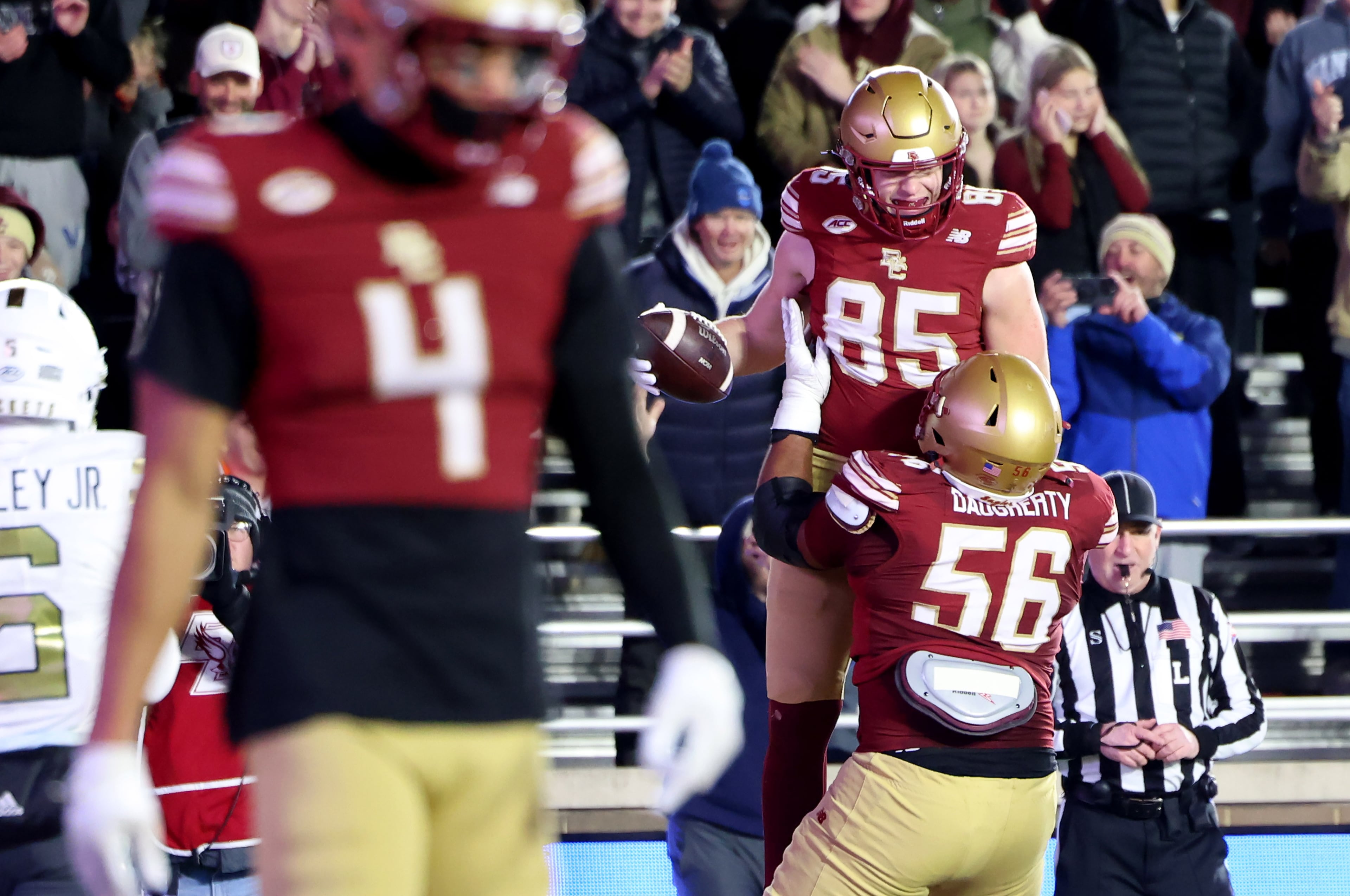 Boston College offensive lineman Eryx Daugherty (56) lifts tight end Kaelan Chudzinski (85) after Chudzinski scored a touchdown during the first half of an NCAA college football game against Georgia Tech, Saturday, Nov. 15, 2025, in Boston. (AP Photo/Mark Stockwell)