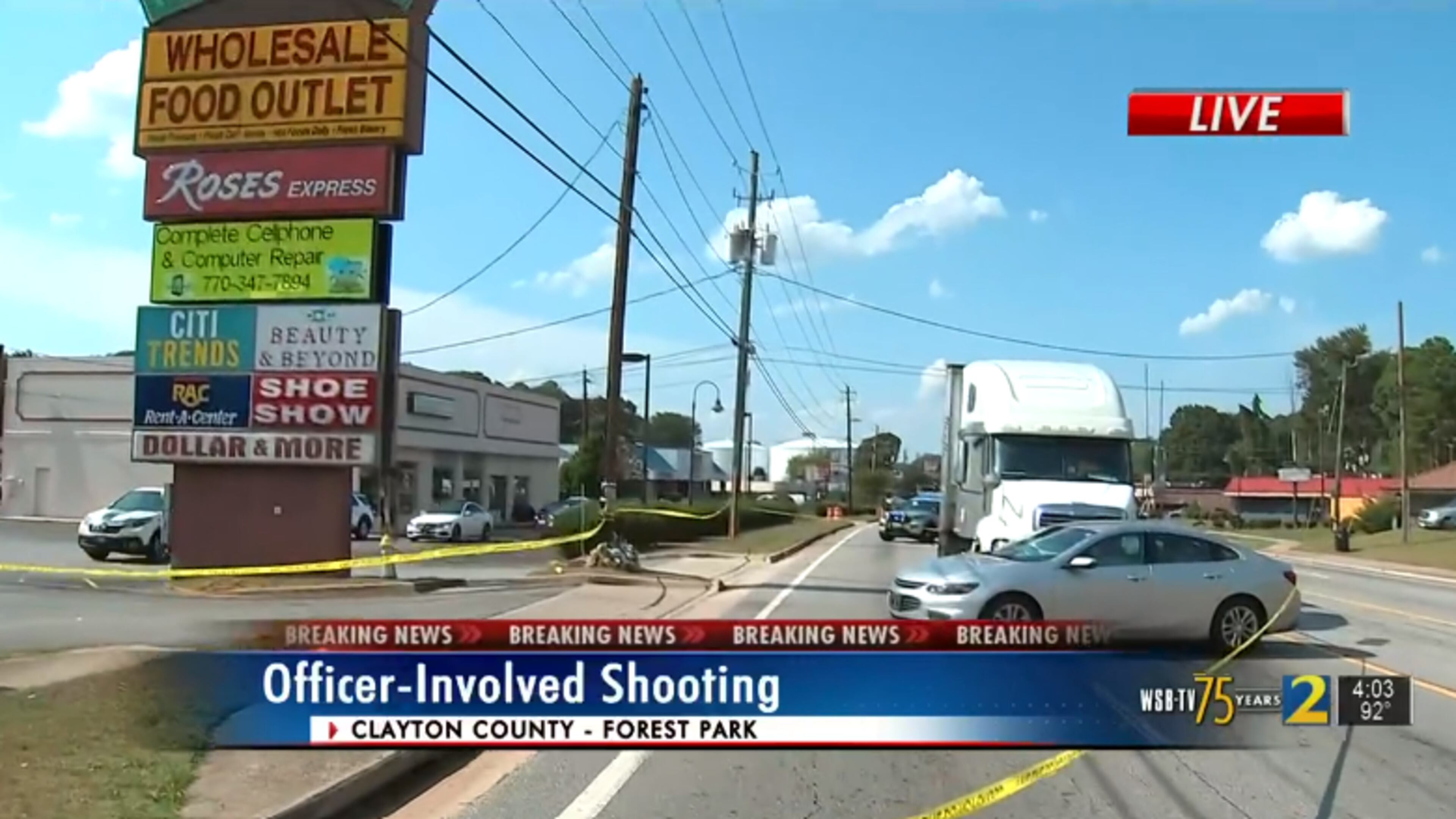 Yellow police tape blocks off the scene of a suspected carjacking and crash that preceded a shooting involving police in Forest Park.