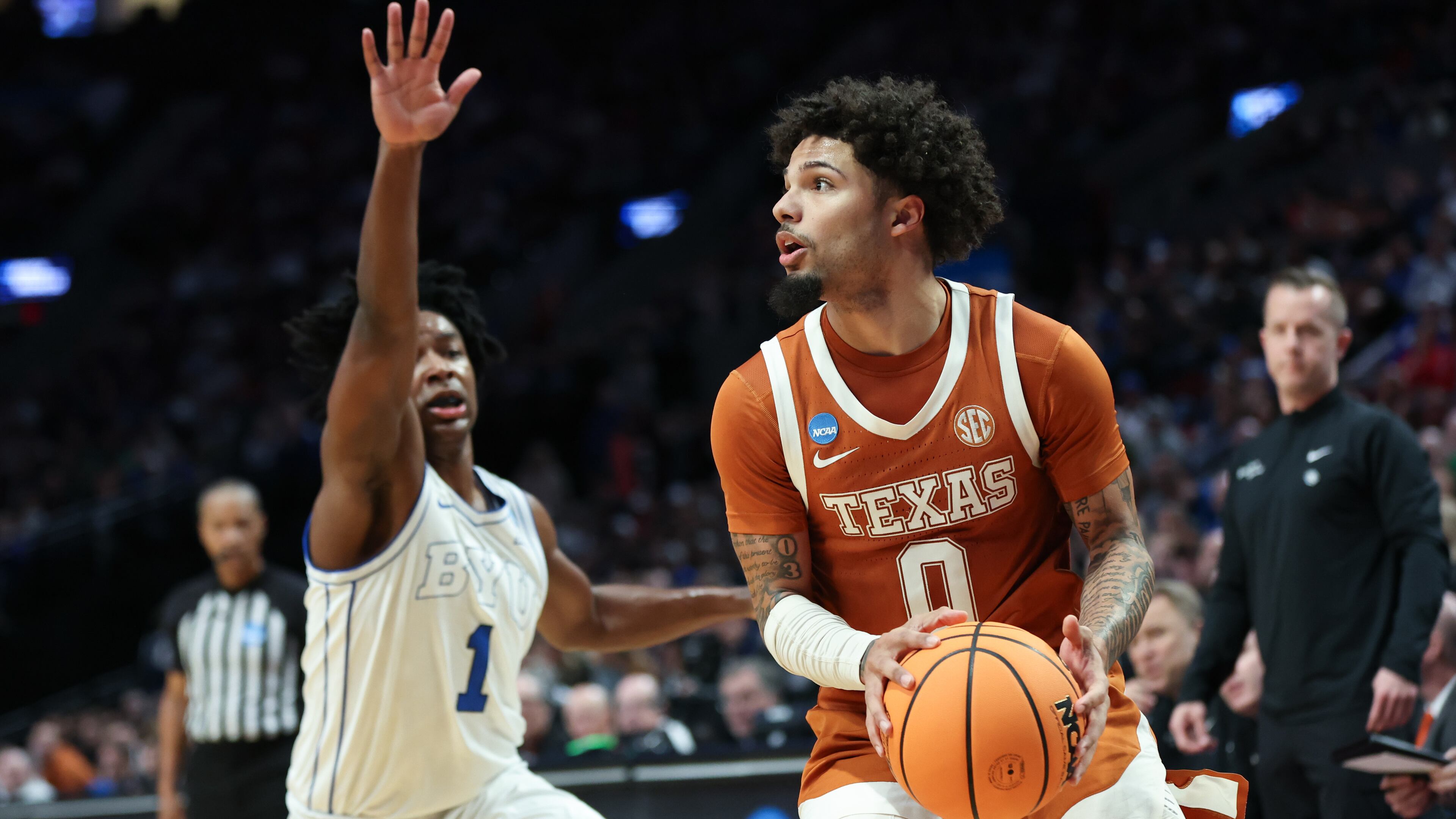 Texas guard Jordan Pope (0) looks to shoot as BYU guard Robert Wright III (1) defends during the first half in the first round of the NCAA college basketball tournament Thursday, March 19, 2026, in Portland, Ore. (AP Photo/Amanda Loman)