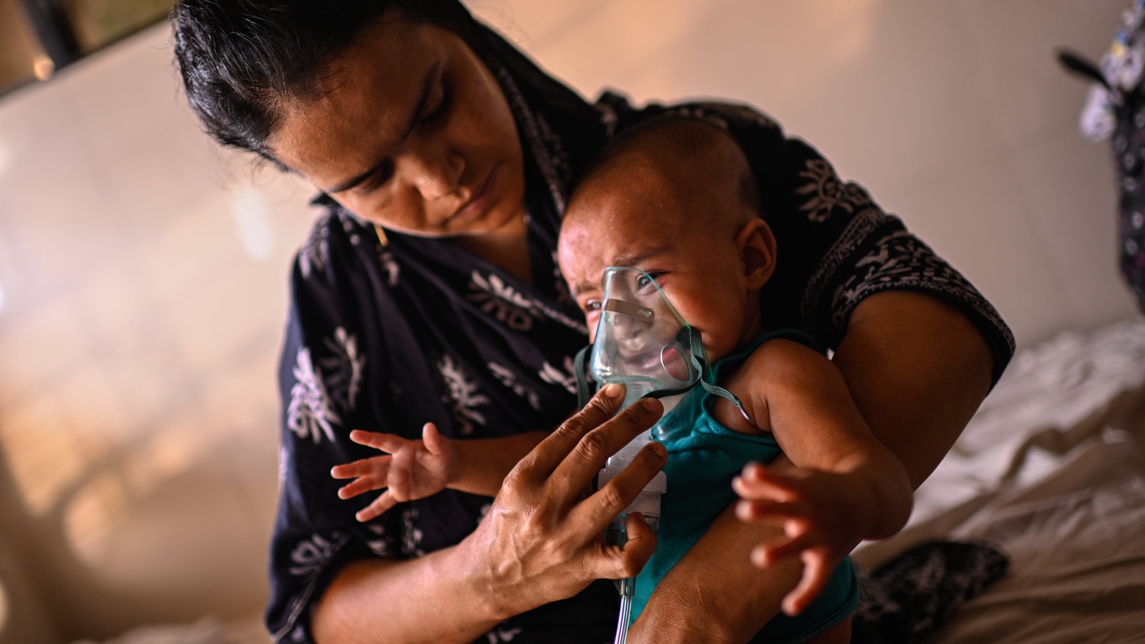 A mother administers a nebulizer treatment for her child suffering from measles at the Infectious Diseases Hospital in Dhaka, Bangladesh, Monday, April 6, 2026, amid a countrywide outbreak. (AP Photo/Mahmud Hossain Opu)