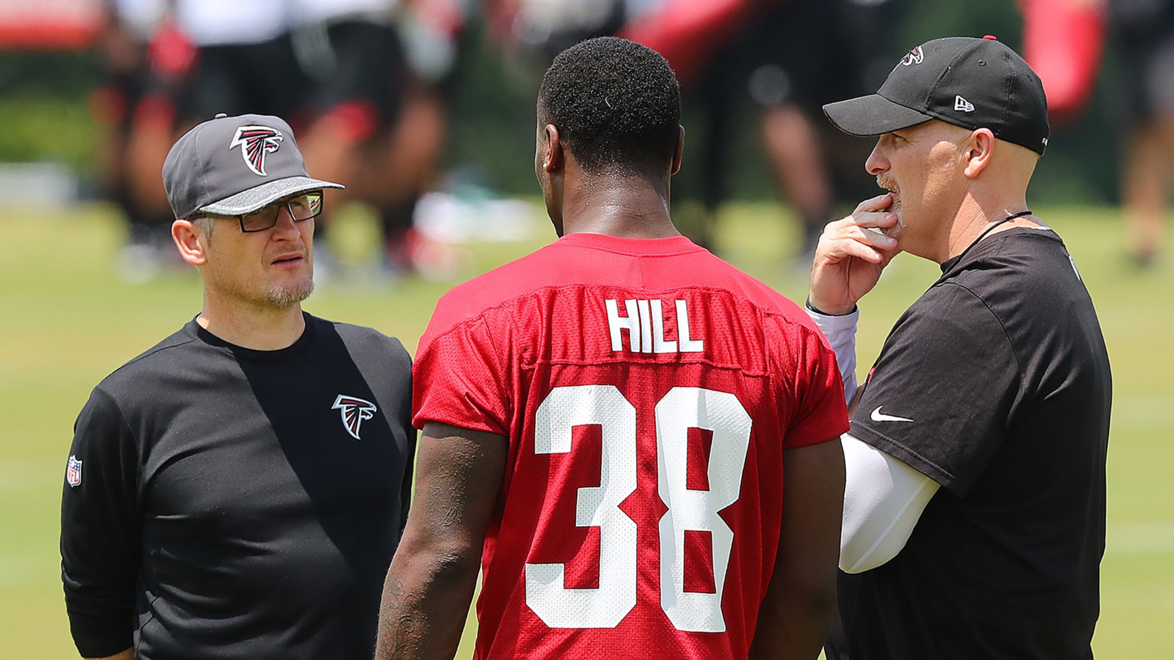 May 12, 2017, Flowery Branch: Falcons head coach Dan Quinn and General Manager Thomas Dimitroff talk with rookie running back Brian Hill, Wyoming, during rookie mini-camp on Friday, May 12, 2017, in Flowery Branch. Curtis Compton/ccompton@ajc.com
