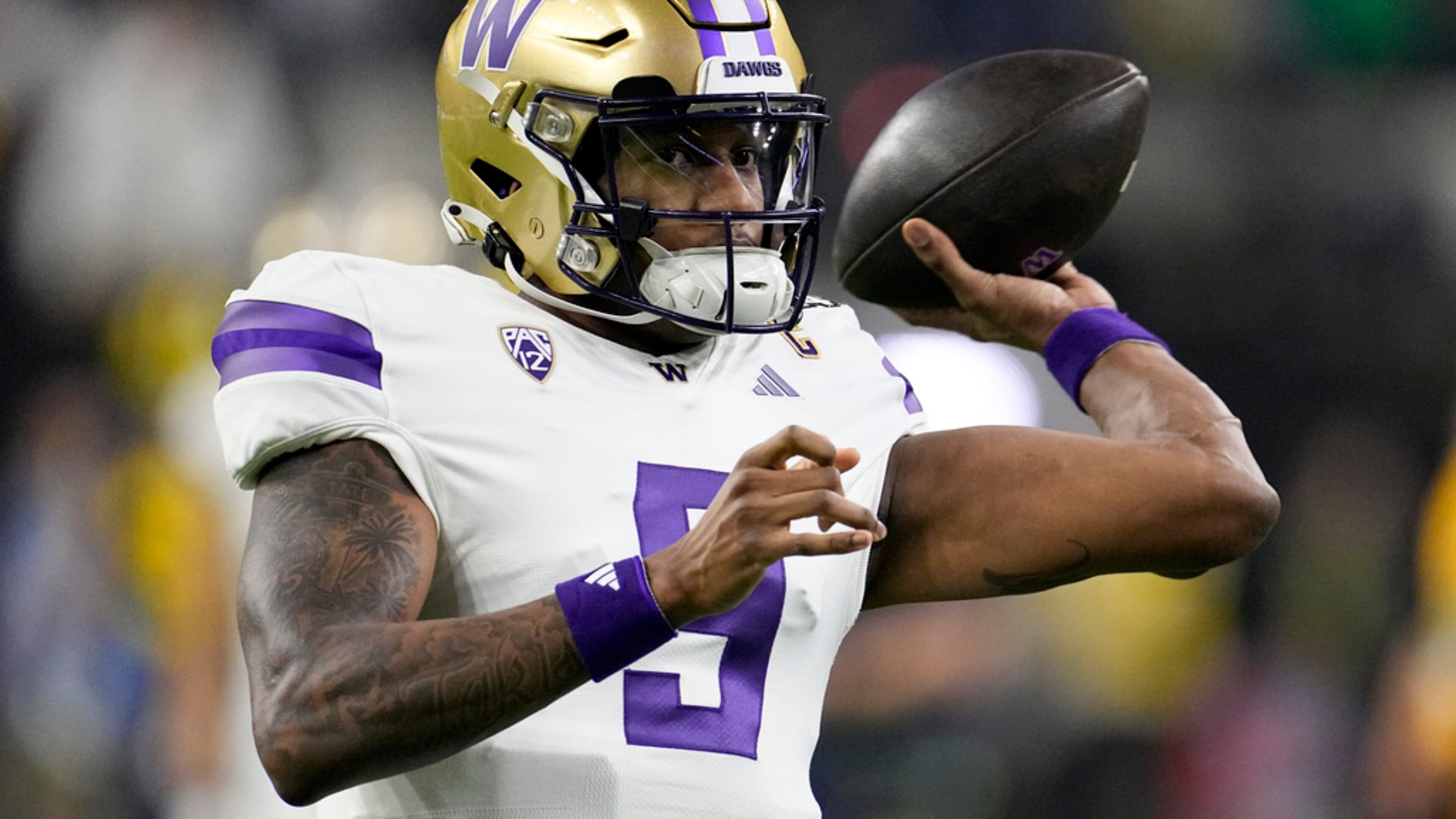 Washington quarterback Michael Penix Jr. warms up before the national championship NCAA College Football Playoff game between Washington and Michigan Monday, Jan. 8, 2024, in Houston. (AP Photo/David J. Phillip)