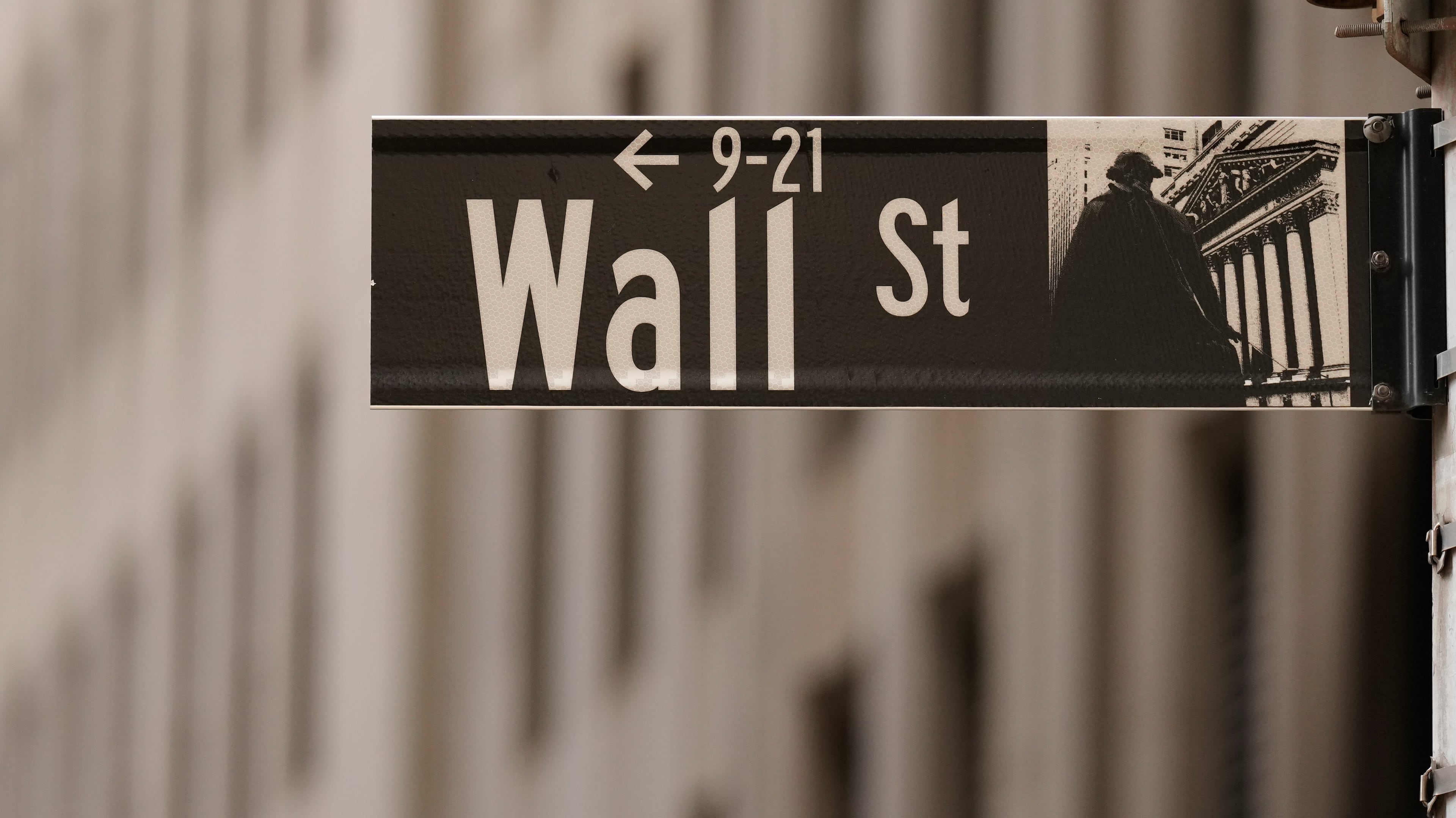 FILE - A Wall Street sign is seen outside of the New York Stock Exchange in New York, Monday, March 30, 2026. (AP Photo/Seth Wenig, File)