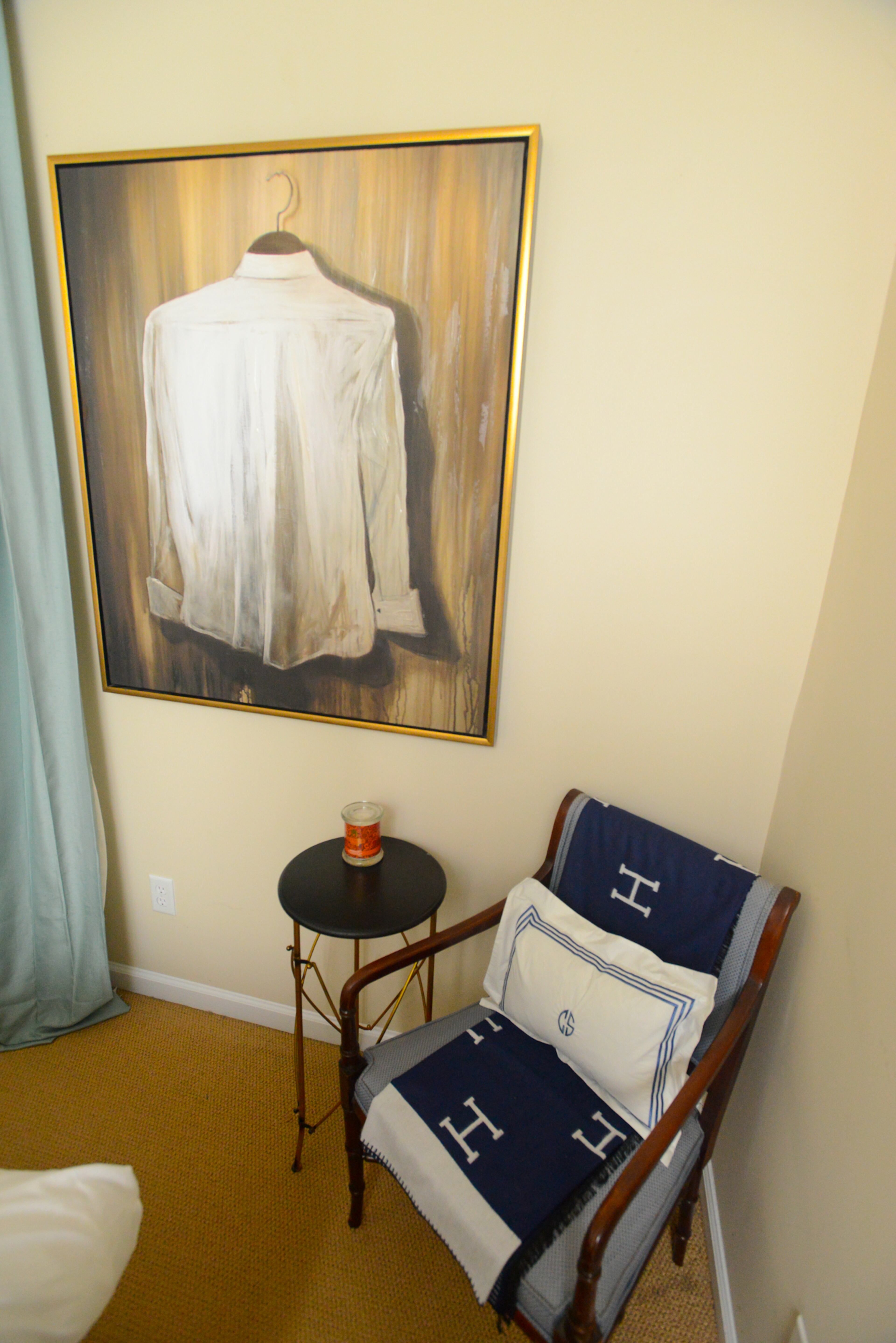 Artwork of a man's shirt from Jay Scott Studios provides a focal point alongside a chair that homeowner Travis Snyder found on Craigslist.