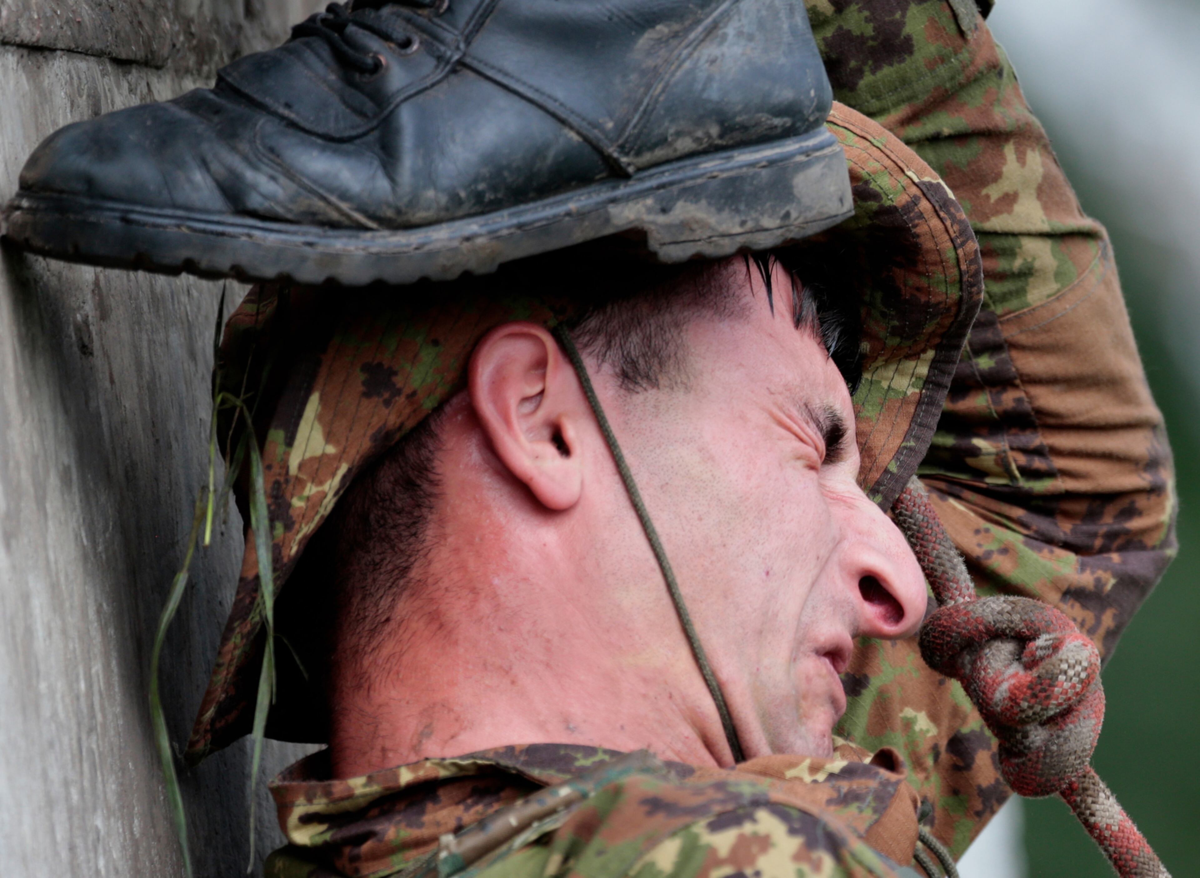 An Armenian soldier grimaces during his team's run during the Army Scout Masters competition, part of Army Games, outside Novosibirsk, 2900 km (some 1800 miles) east of Moscow, Russia, on Wednesday, Aug. 2, 2017. (AP Photo/Ivan Sekretarev)