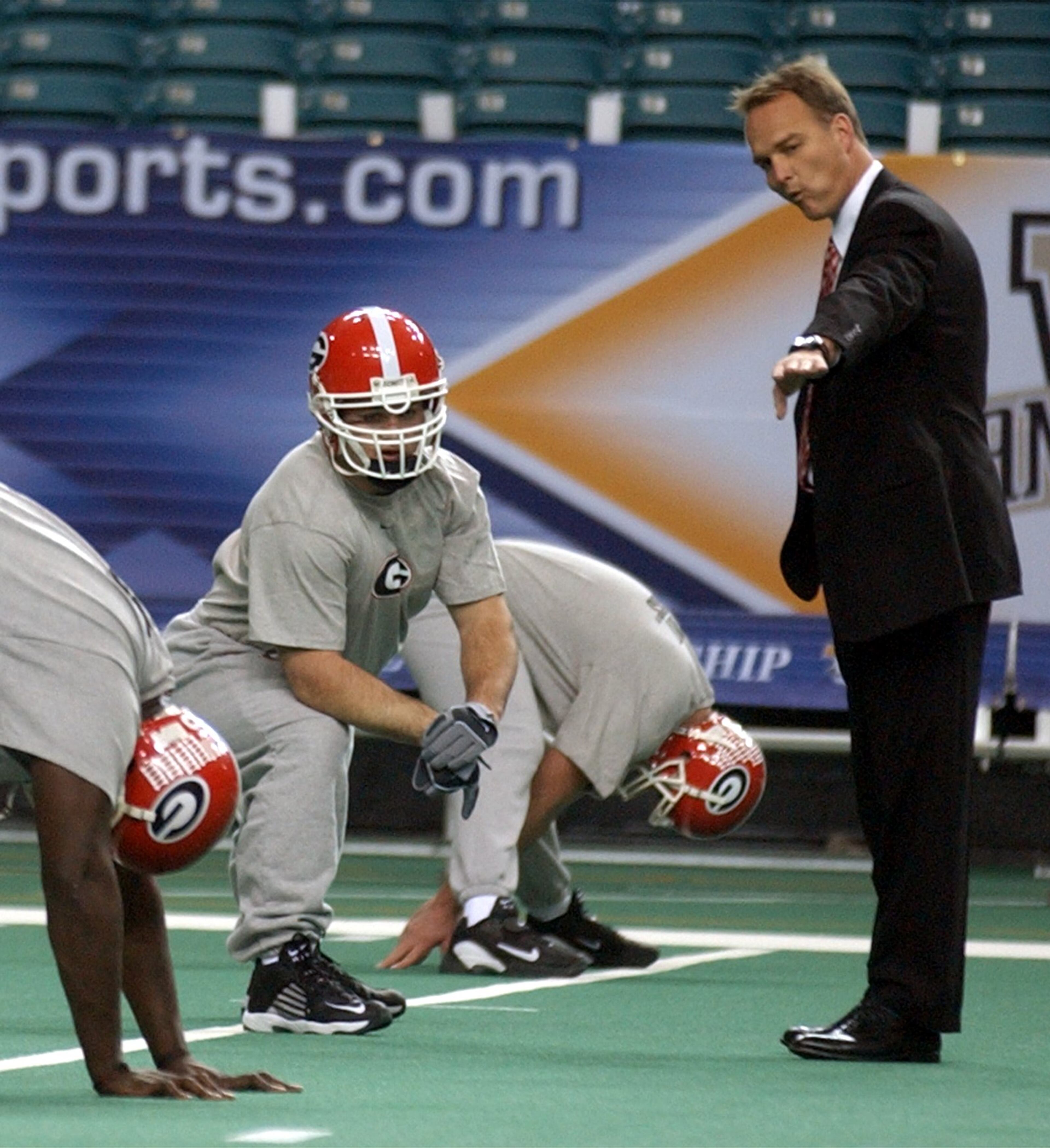 The Dogs advanced to the SEC championship game at the Georgia Dome in 2002. Richt talks to fullback J.T. Wall during a light practice.