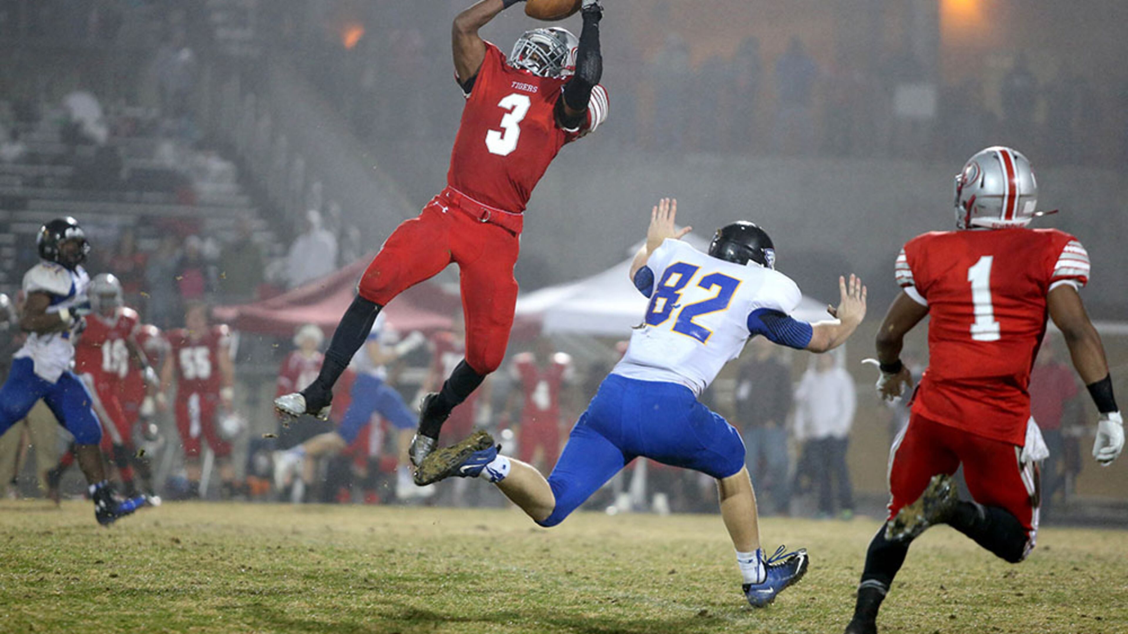 December 5, 2014 - Lawrenceville, Ga: Archer defensive back Dylan Singleton (3) makes an interception over Etowah tight end Patrick Oliver (82) in the first half of their game against Etowah in the Class AAAAAA semifinal Friday night at Archer High School in Lawrenceville, Ga., December 5, 2014. Singleton returned the interception for a touchdown. PHOTO / JASON GETZ
